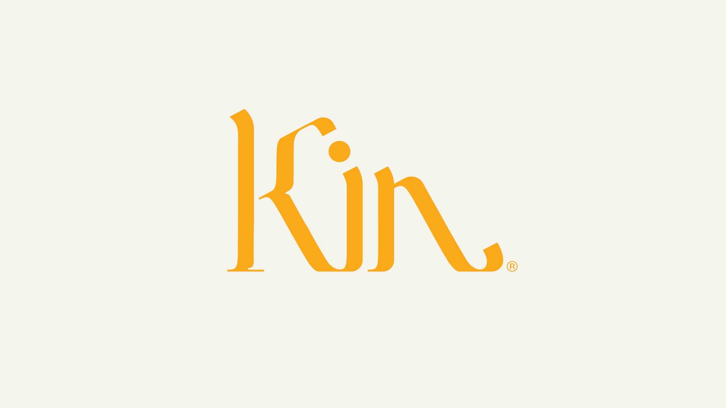 The word 'Kin' written in stylized orange font on a light beige background.