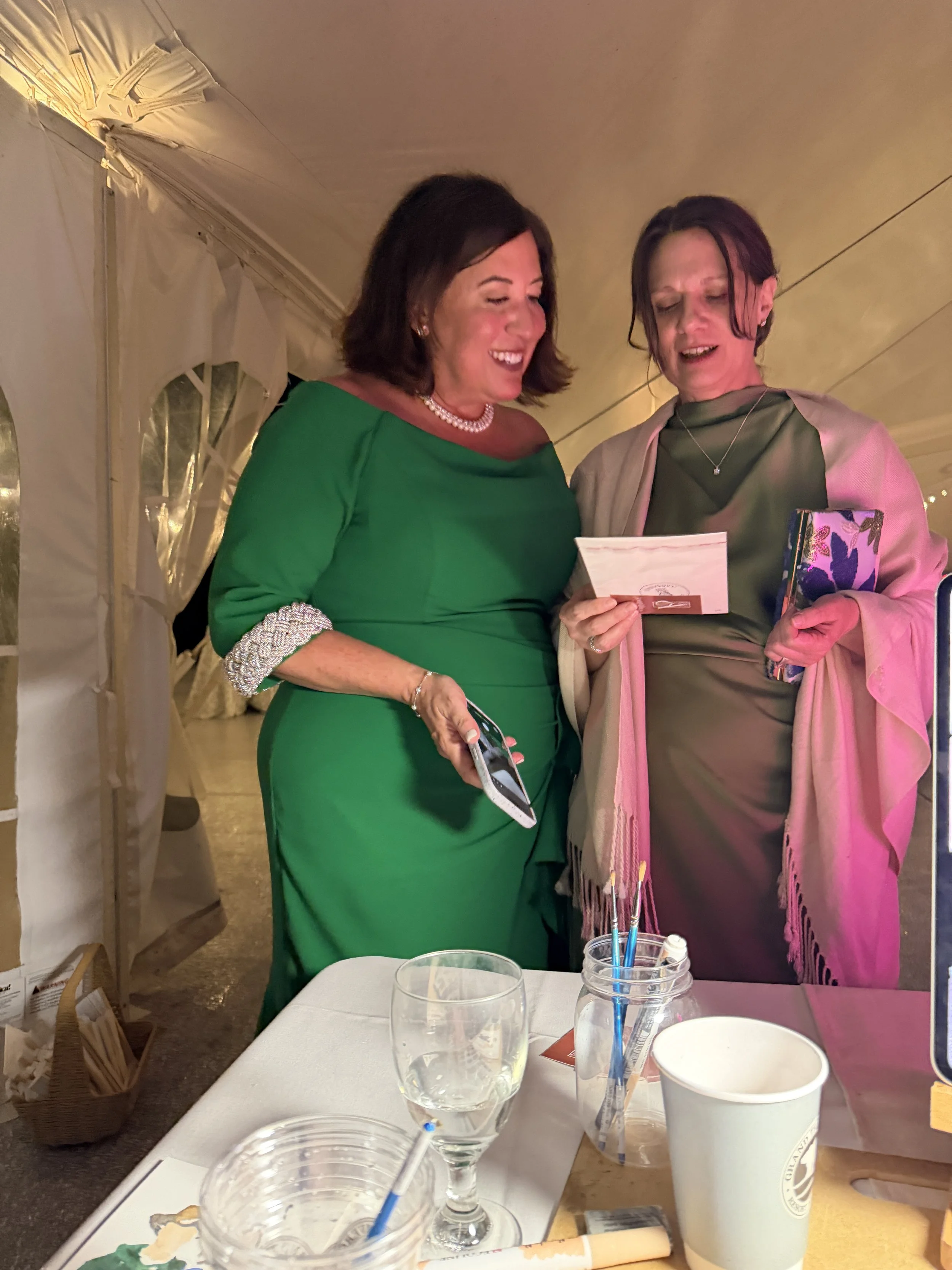 Smiling guest receiving a custom portrait sketch during a company celebration.