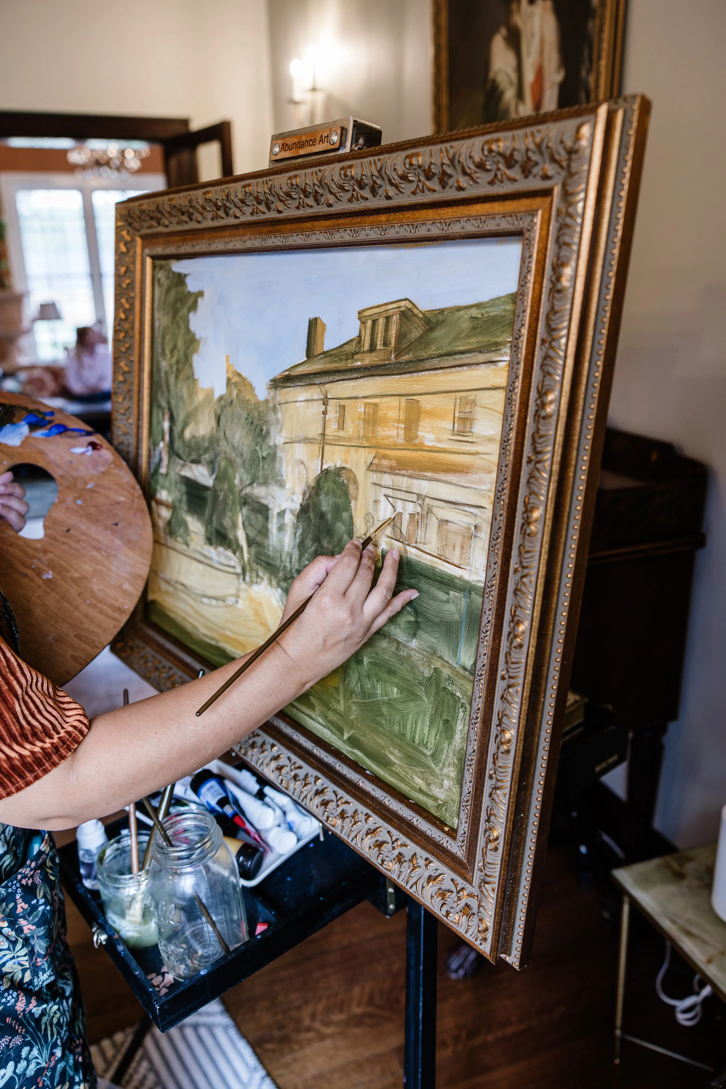 Hallie LeBlanc painting live during the ceremony to capture the light of the site