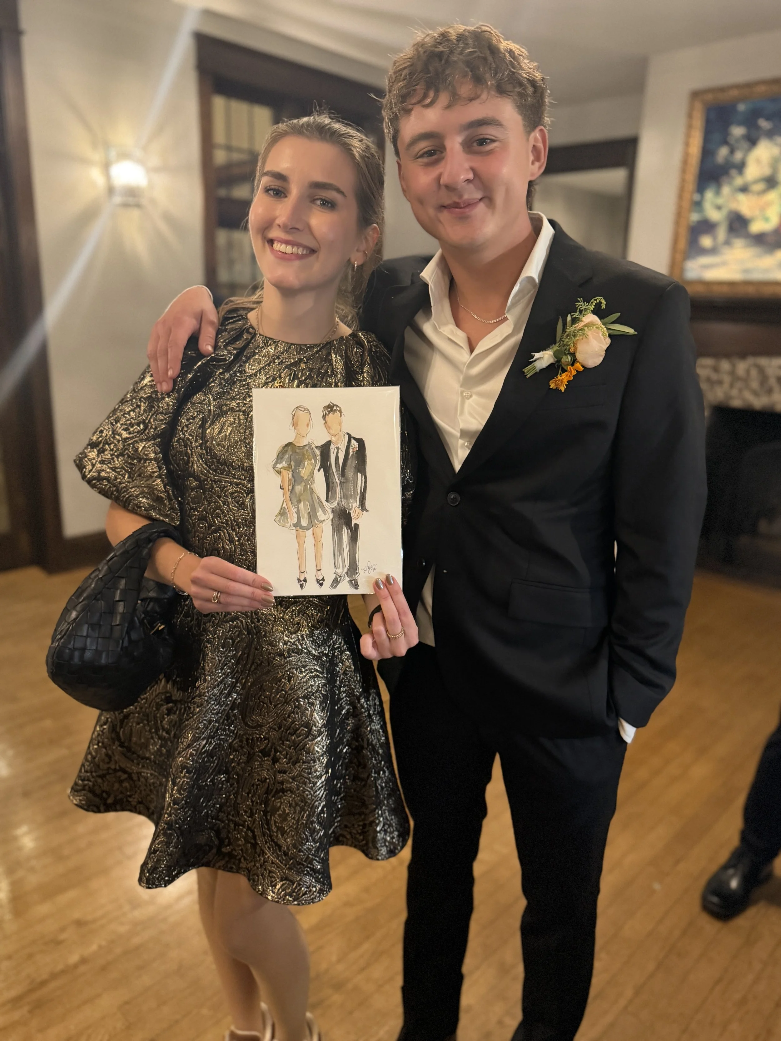 Couple proudly displaying their custom guest sketch at an evening reception.