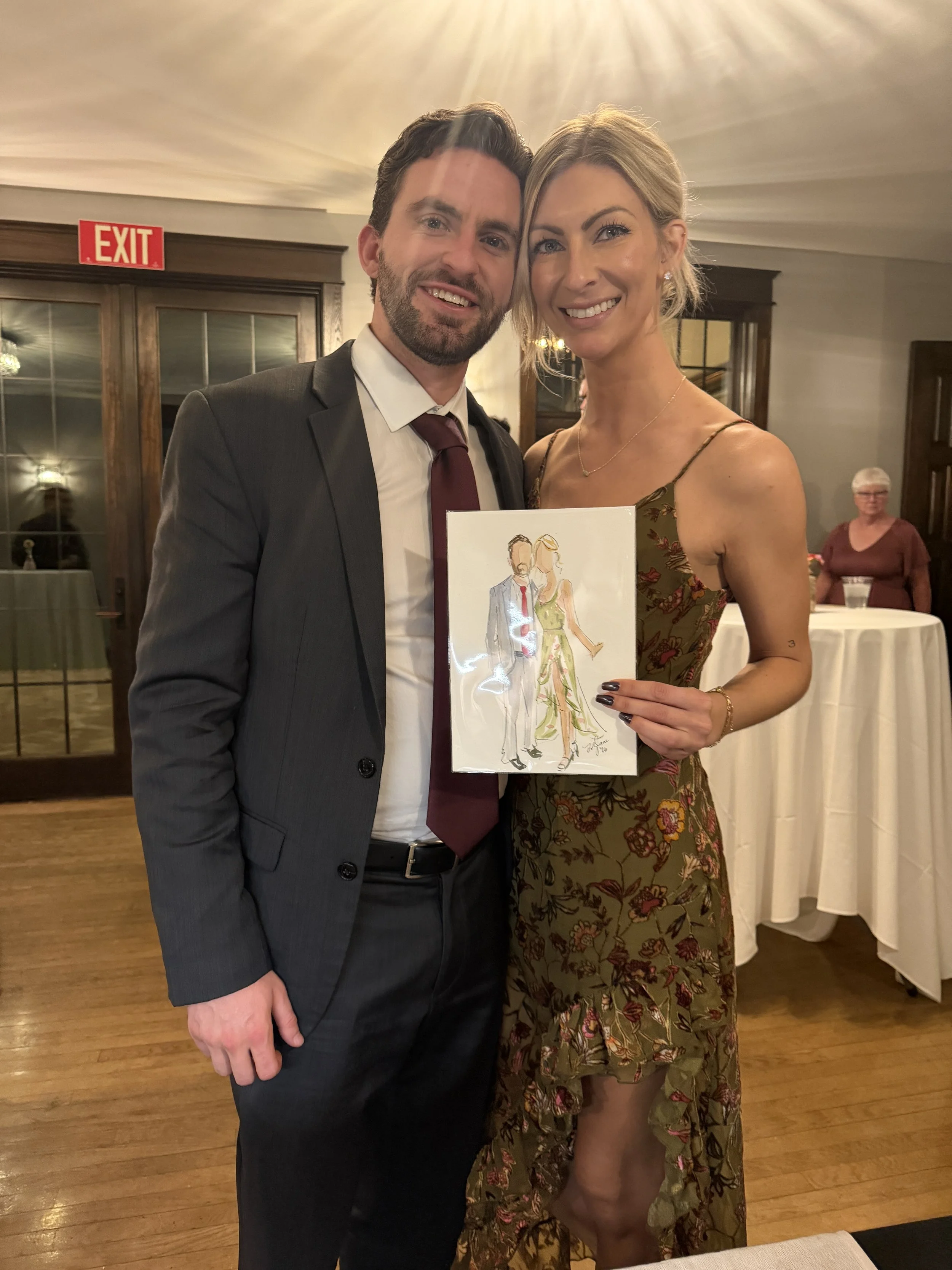 Guests enjoying personalized portrait favors at a company holiday celebration