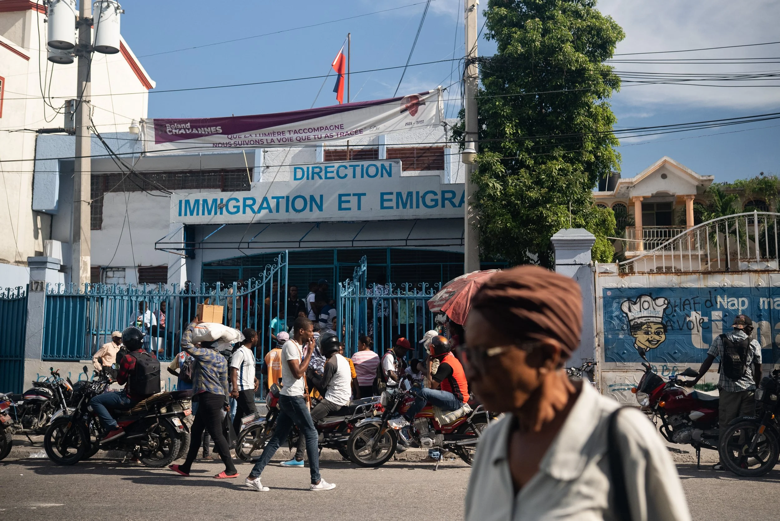 Motorcycle taxi drivers mob an immigration office to apply for the Biden administration's humanitarian parole program for Haitians (part of the CHNV program).