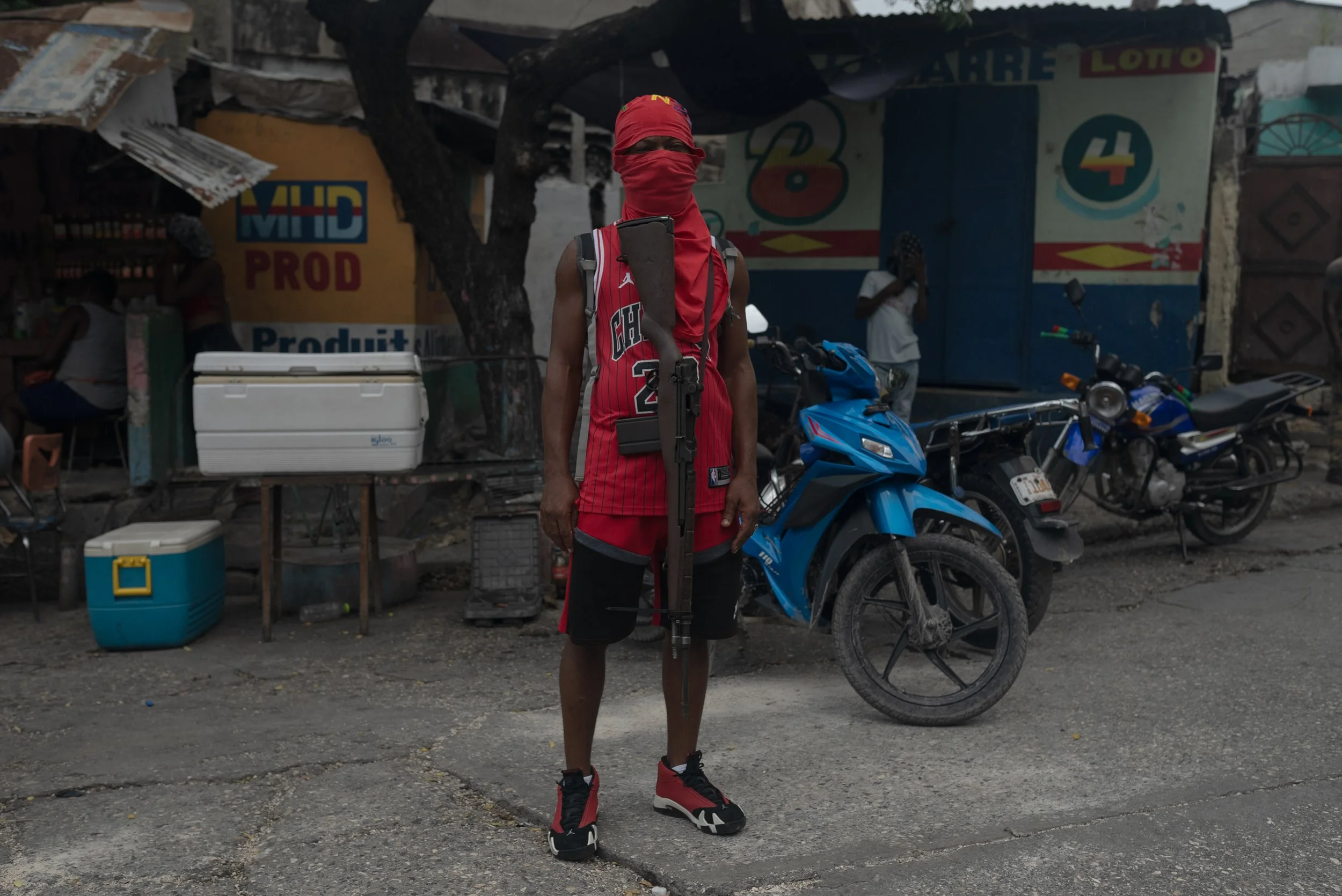 An armed solider stands guard as part of G-9 in Delmas 4, Port-au-Prince.