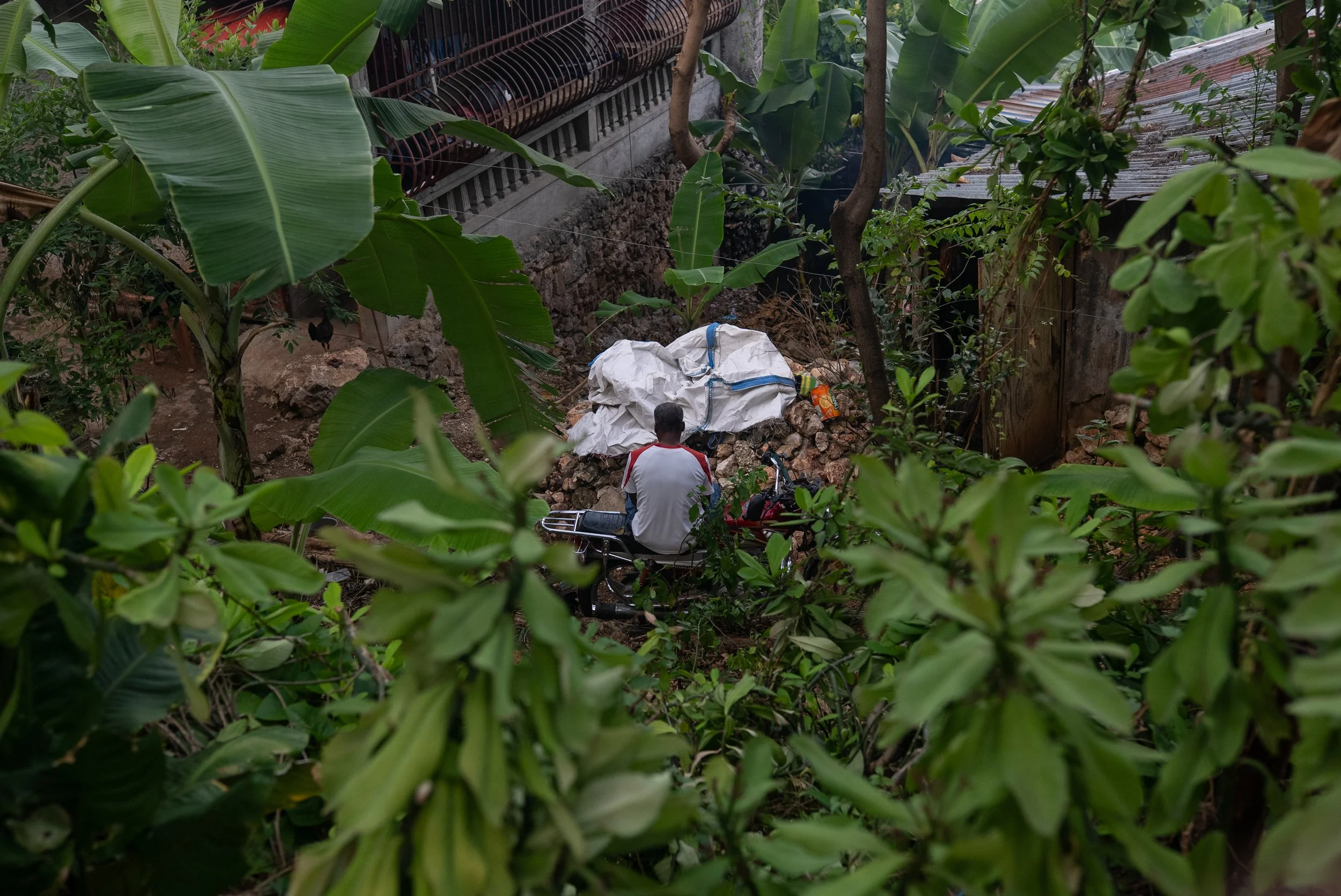 Jean-Claude Bonhomme, 52, hasn't driven his motorcycle in two months — the cost of fuel has made it impossible. He has managed hypertension for twenty years and struggles to access his medication. He and his wife spend most of their time at church. T