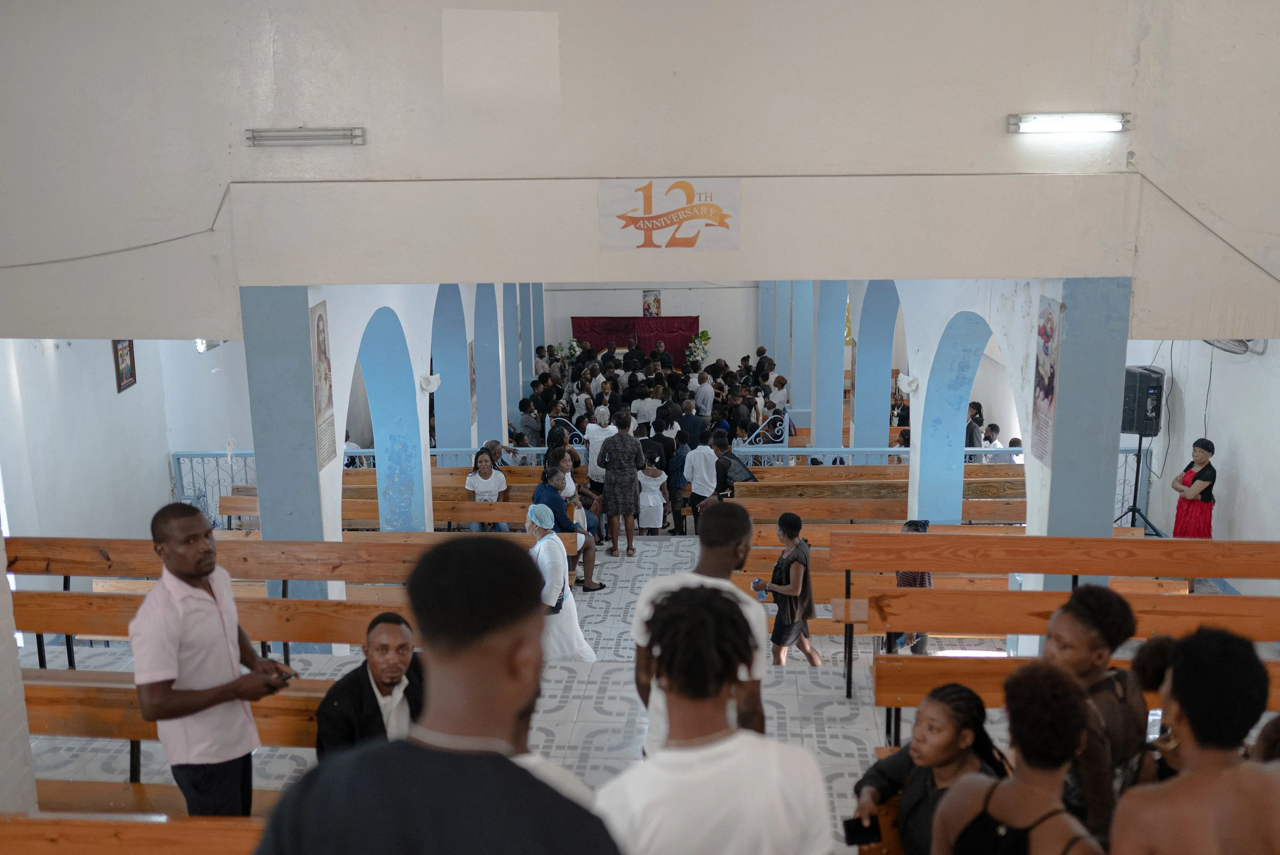 Motorcycle drivers descend for the funeral of Johnny Alexis, 33, who dropping off a client on a run as a motorcycle taxi driver and was killed in the crossfire between gangs and police in downtown Port-au-Prince on Nov. 11, 2022.