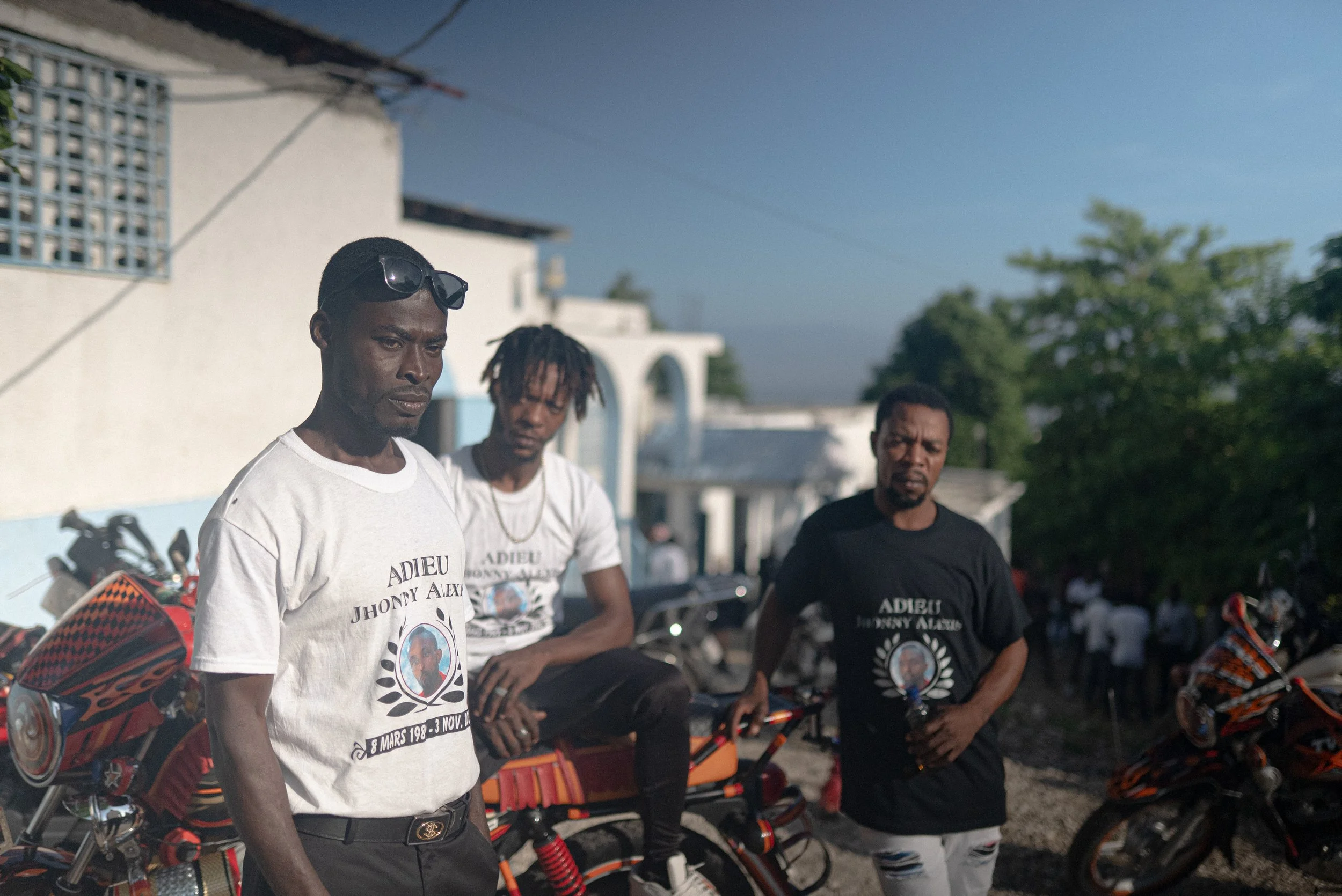 Mucsone, and other motorcycle taxi drivers at the funeral of Johnny Alexis, 33.