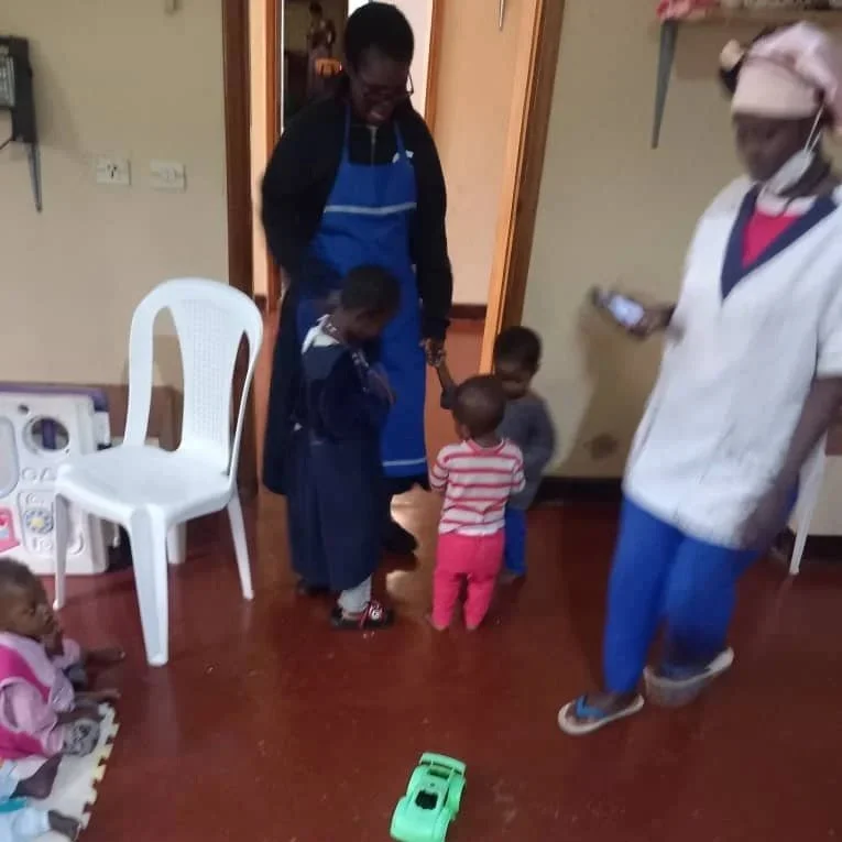 Novice Maureen Anyega playing with children
