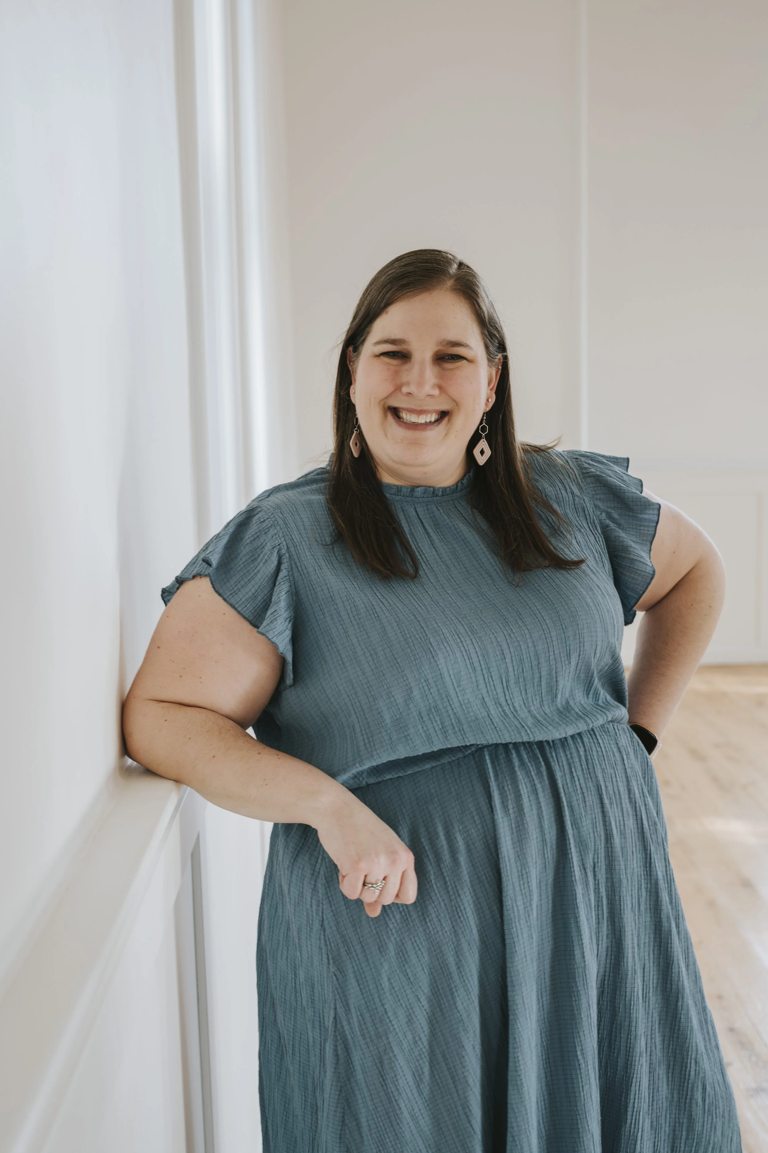 Bobbi-Jo Molokken, therapist, wearing blue dress, smiling - Iowa ADHD trauma counselor