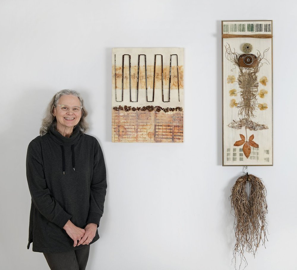 Artist Leslie Yolen posing with her work at 287 Main