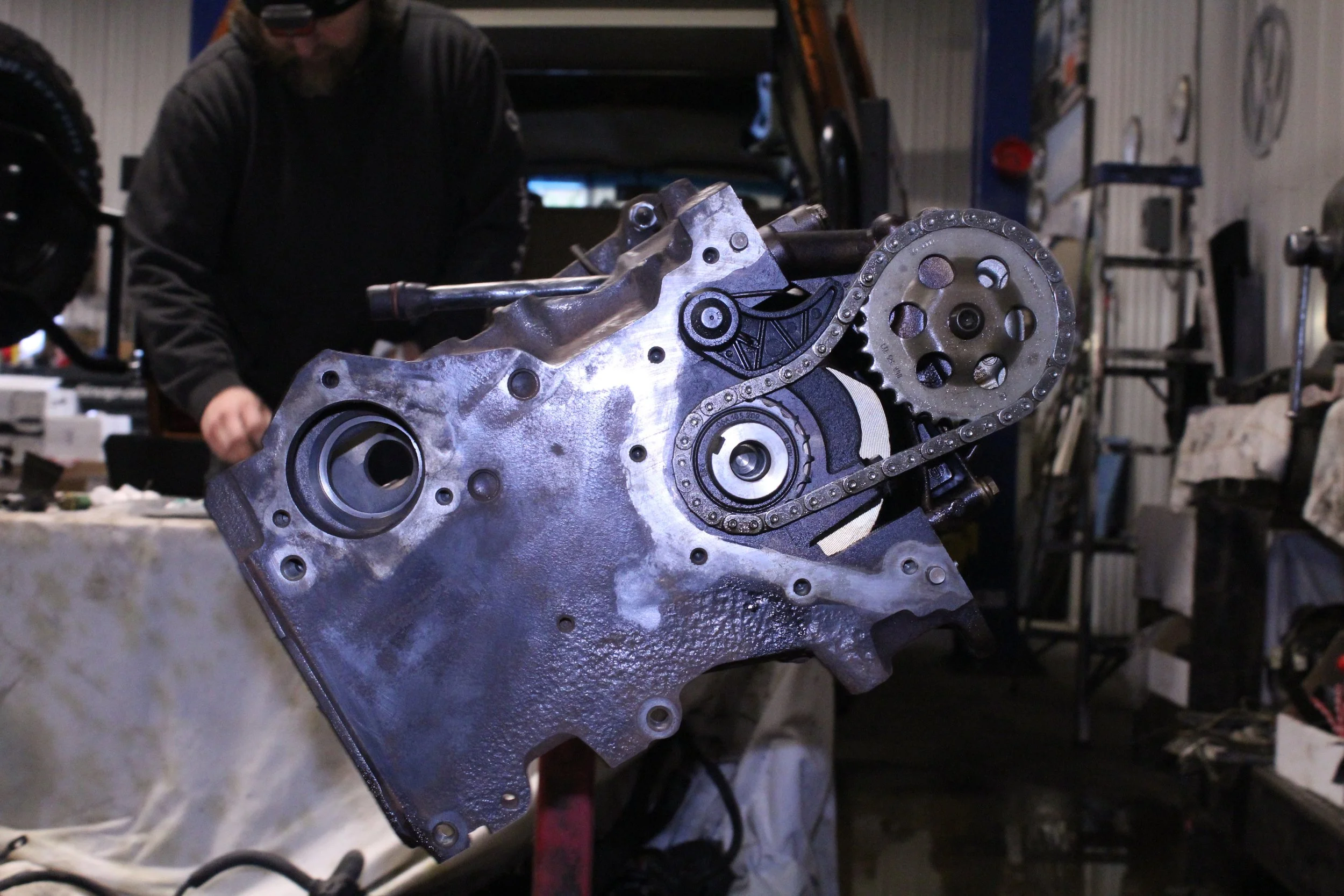Mechanic fixing a car engine in a garage.