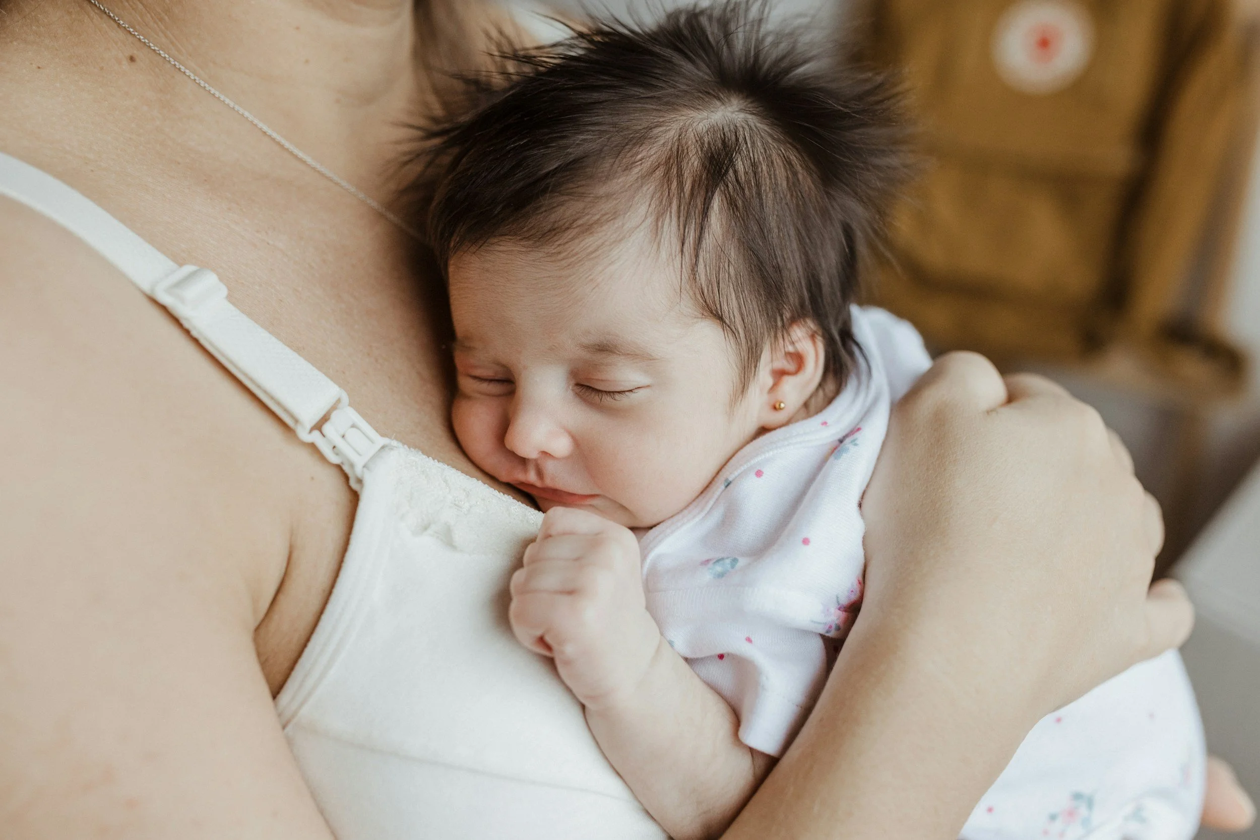 baby sleeping on mother's chest