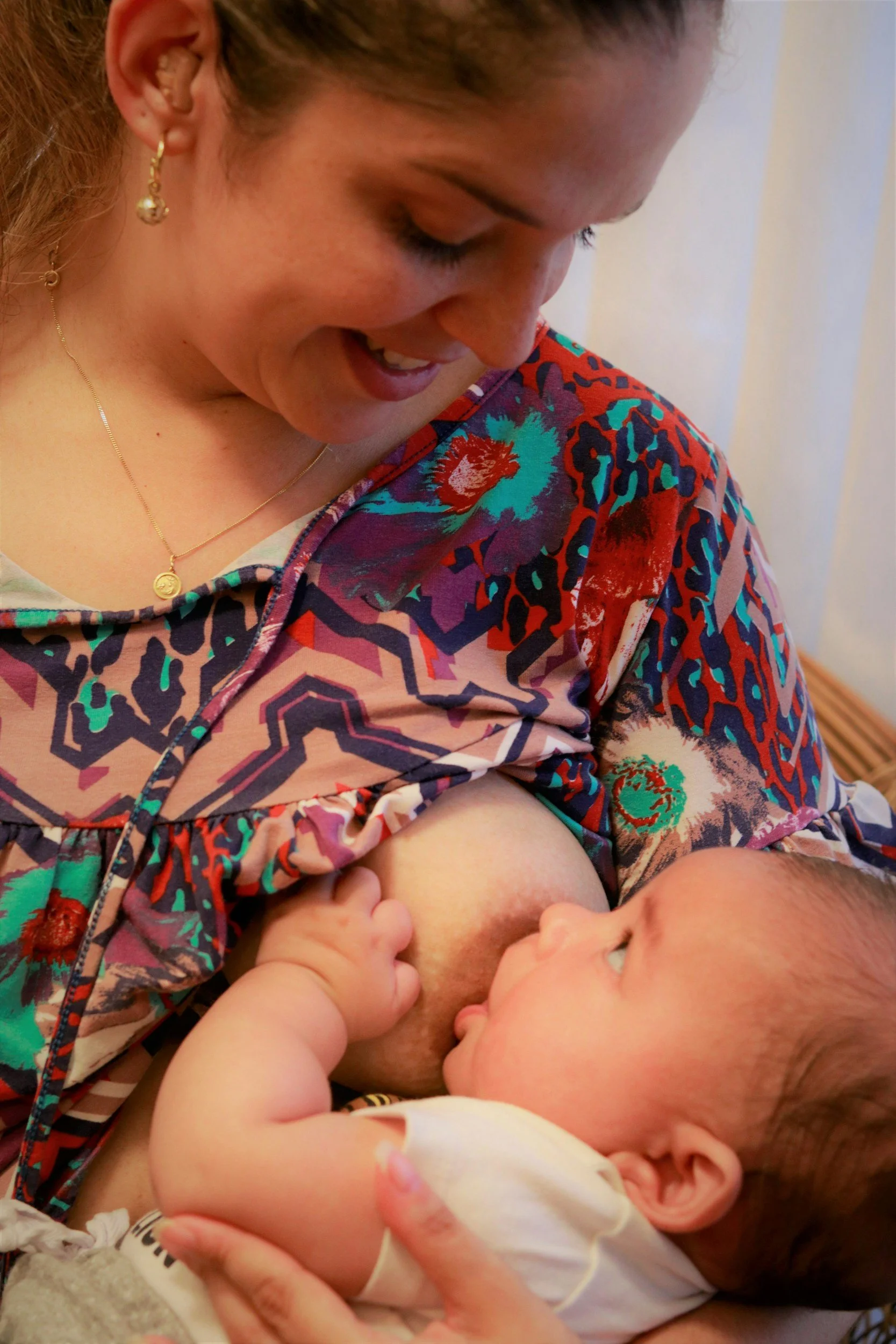 Mother looking at her baby while breastfeeding