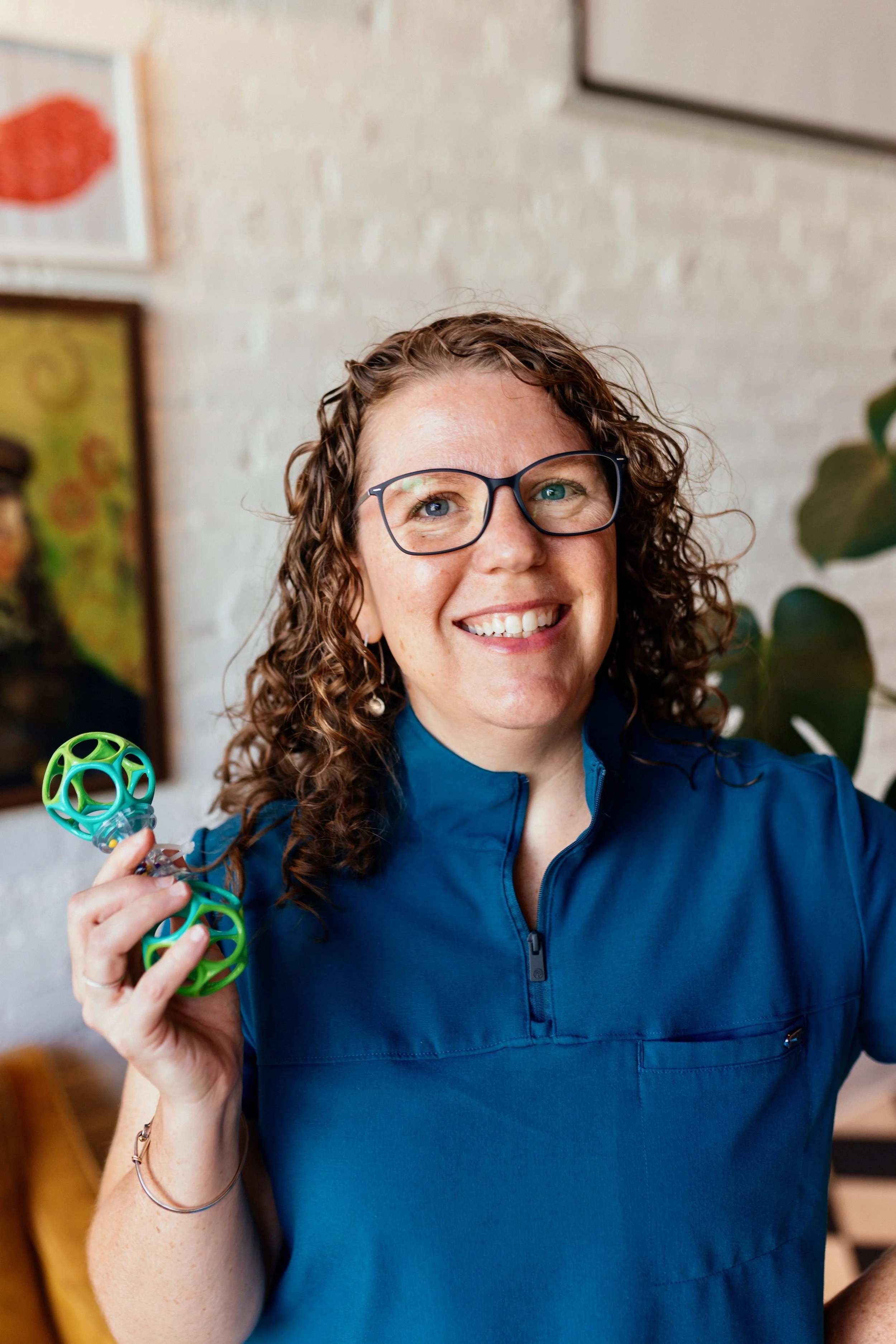Owner, Nicole, a female holding a rattle
