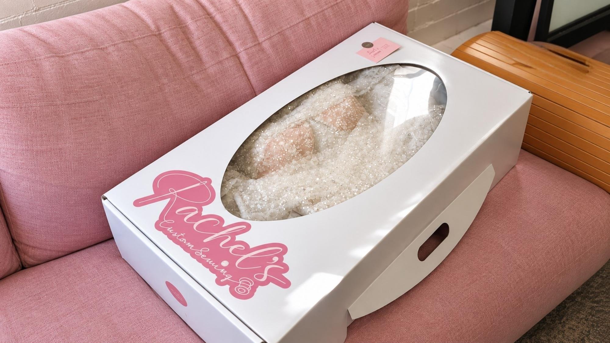 Steamed wedding dress garment box with a bridal gown inside.