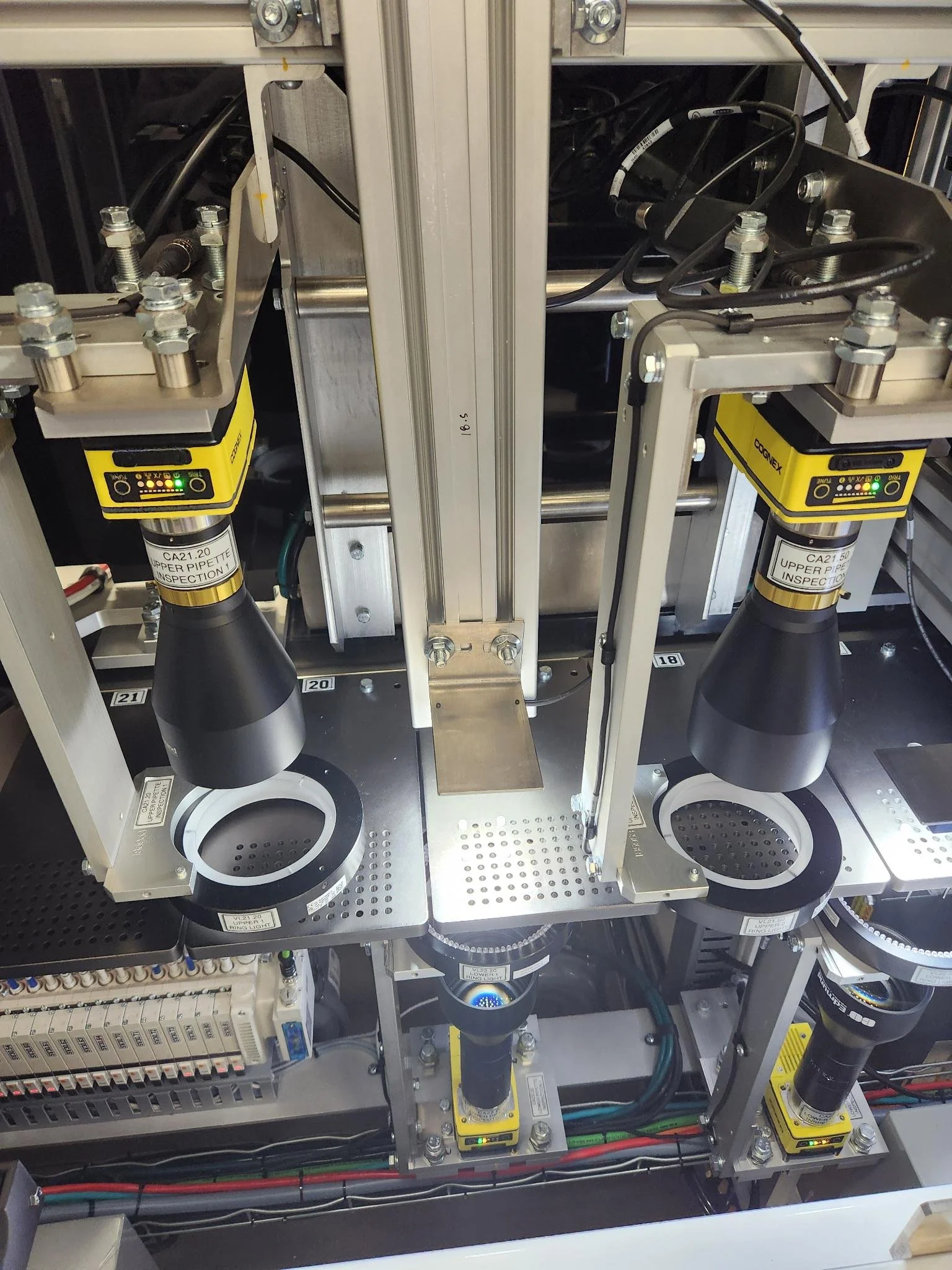 Close-up view of industrial machinery with cognex components, electrical wiring, manufacturing or automation processes.