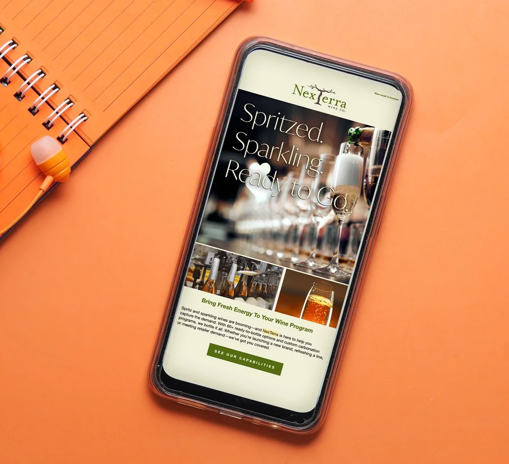 Phone on table with email marketing campaign by Path Creative