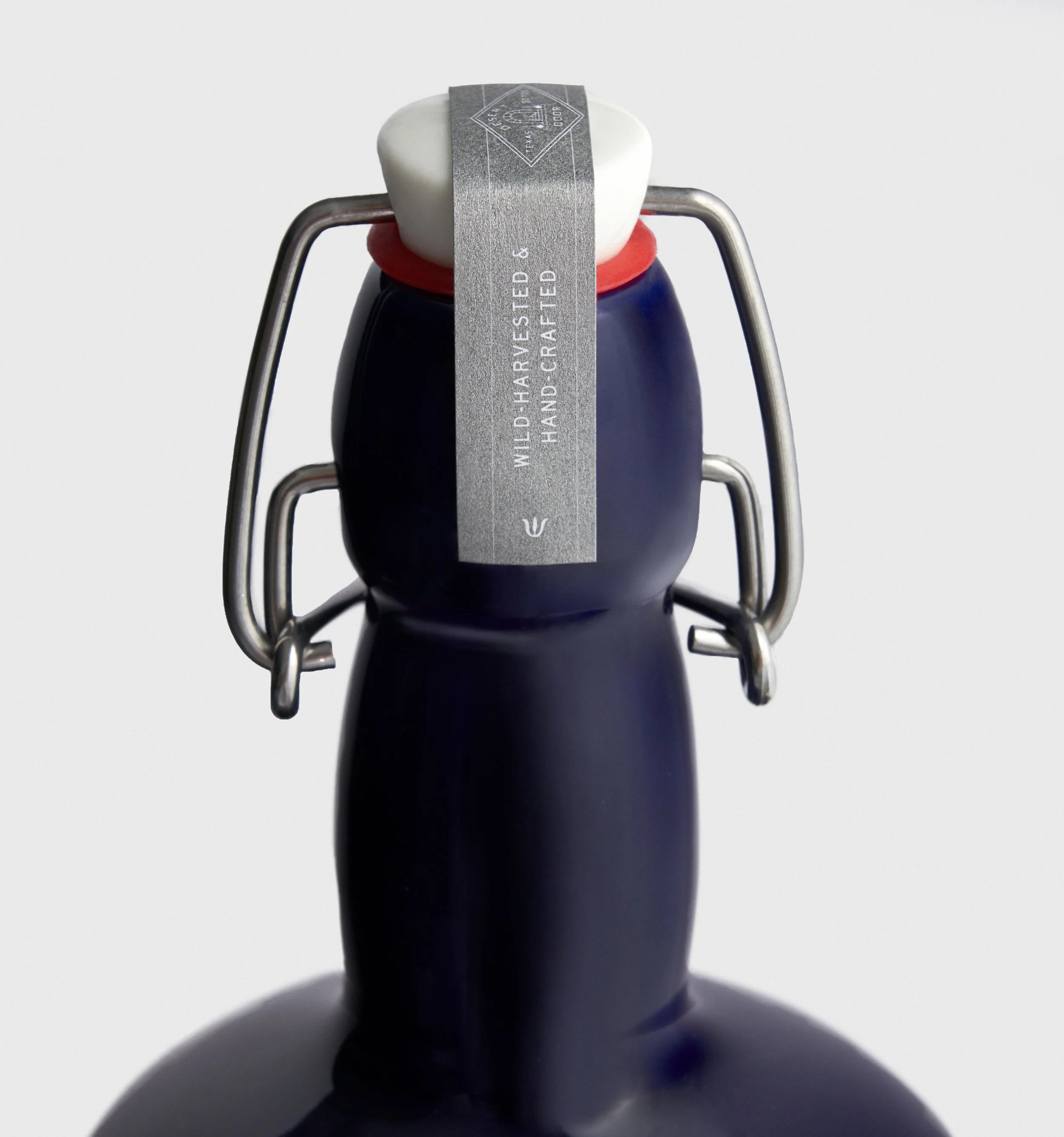 French Fox Design: Desert Door Texas Sotol, Packaging Design: Blue Bottle with Metallic Silver Top Cap Strap