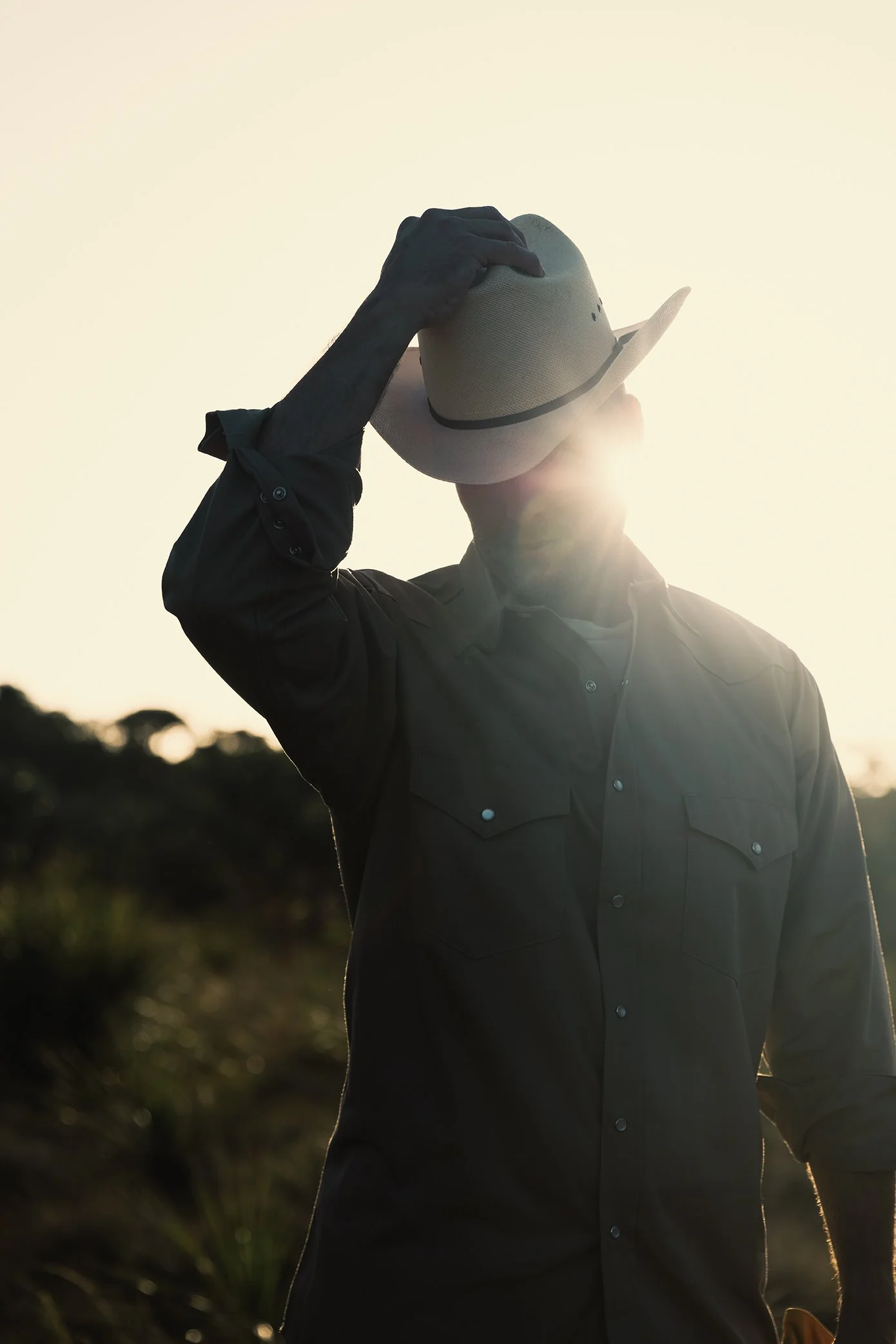 French Fox Design: Desert Door Texas Sotol, Lifestyle Photography: Man Taking Off Cowboy Hat