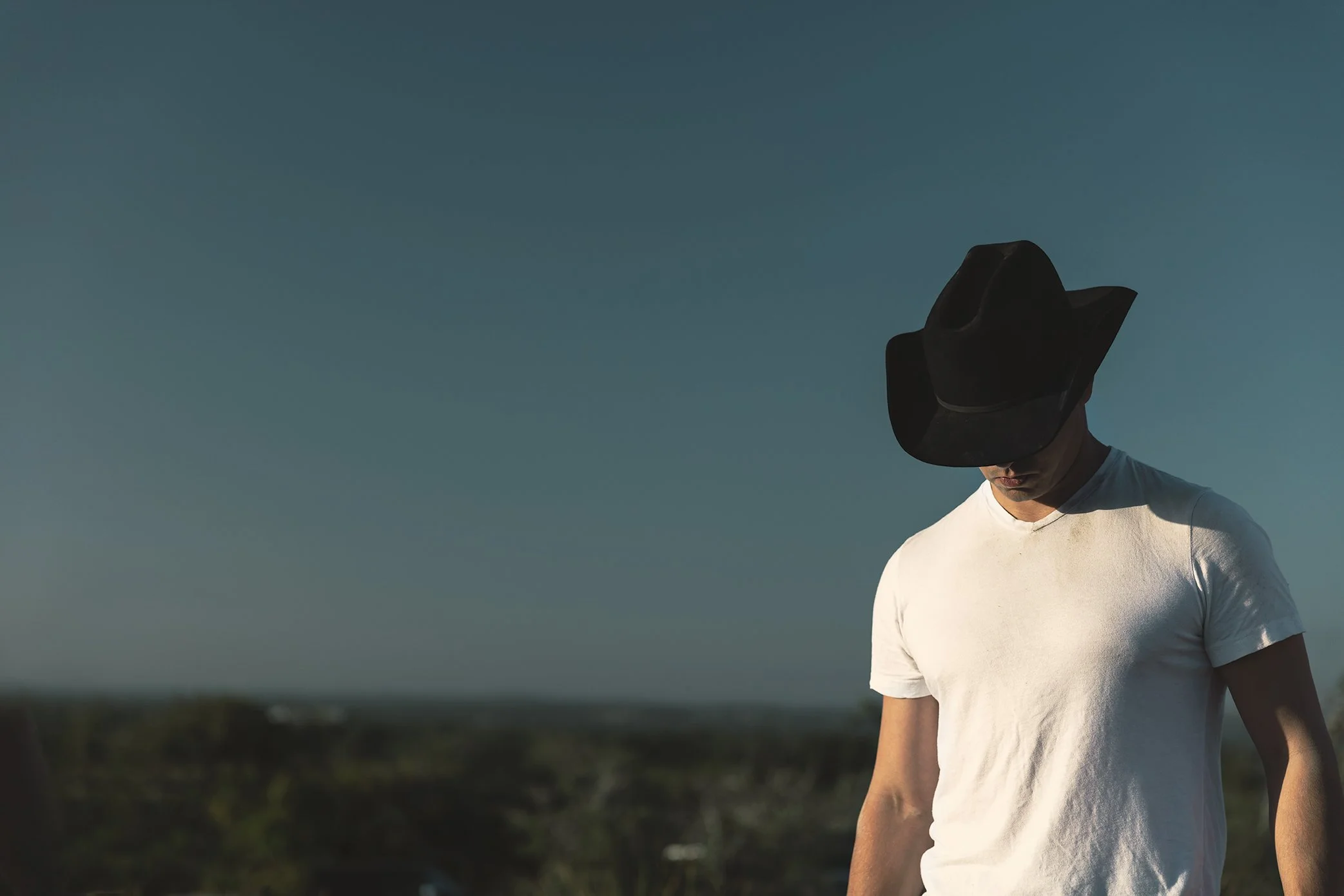 French Fox Design: Desert Door Texas Sotol, Lifestyle Photography: Man in Black Cowboy Hats and White Tshirt