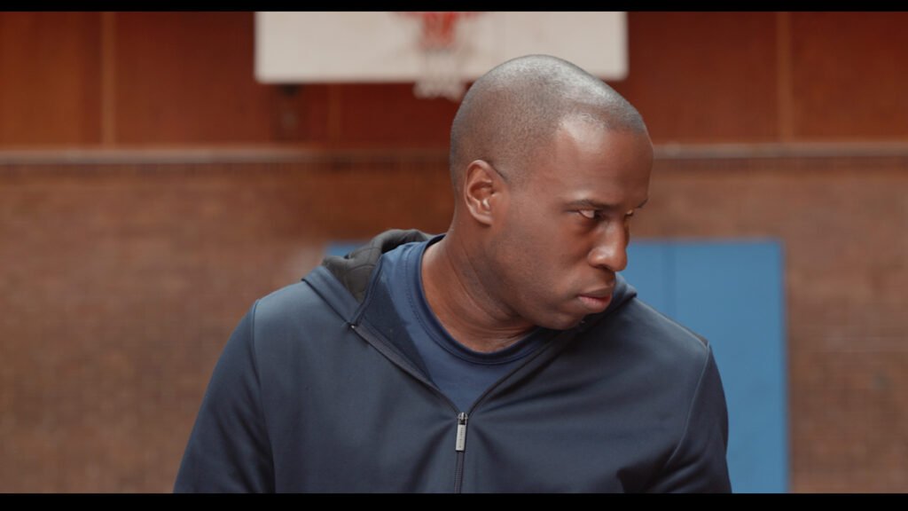 A.T. Branch as Rodger, an OG Bootcamp instructor