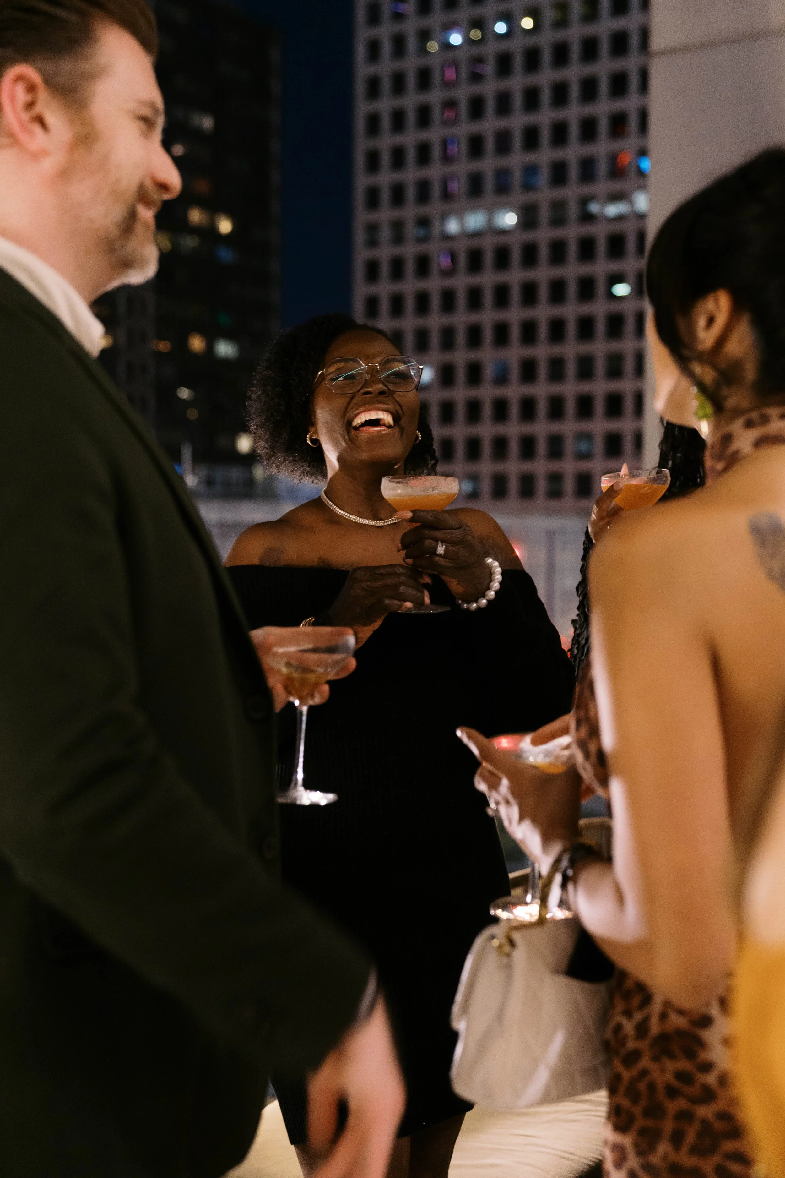 guests laughing with cocktails at Catbird Dallas birthday party