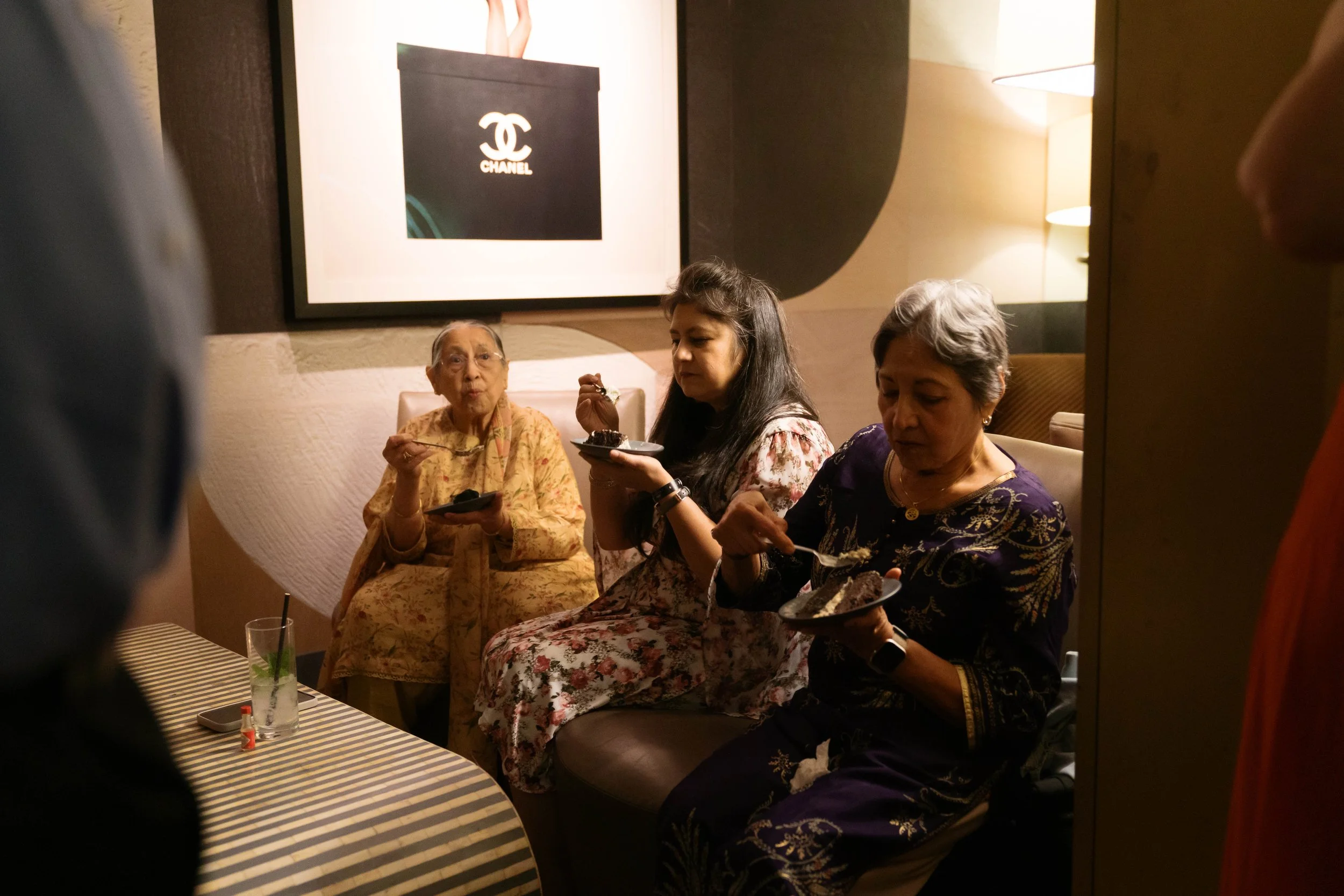 family seated indoors eating cake at Catbird Dallas birthday event