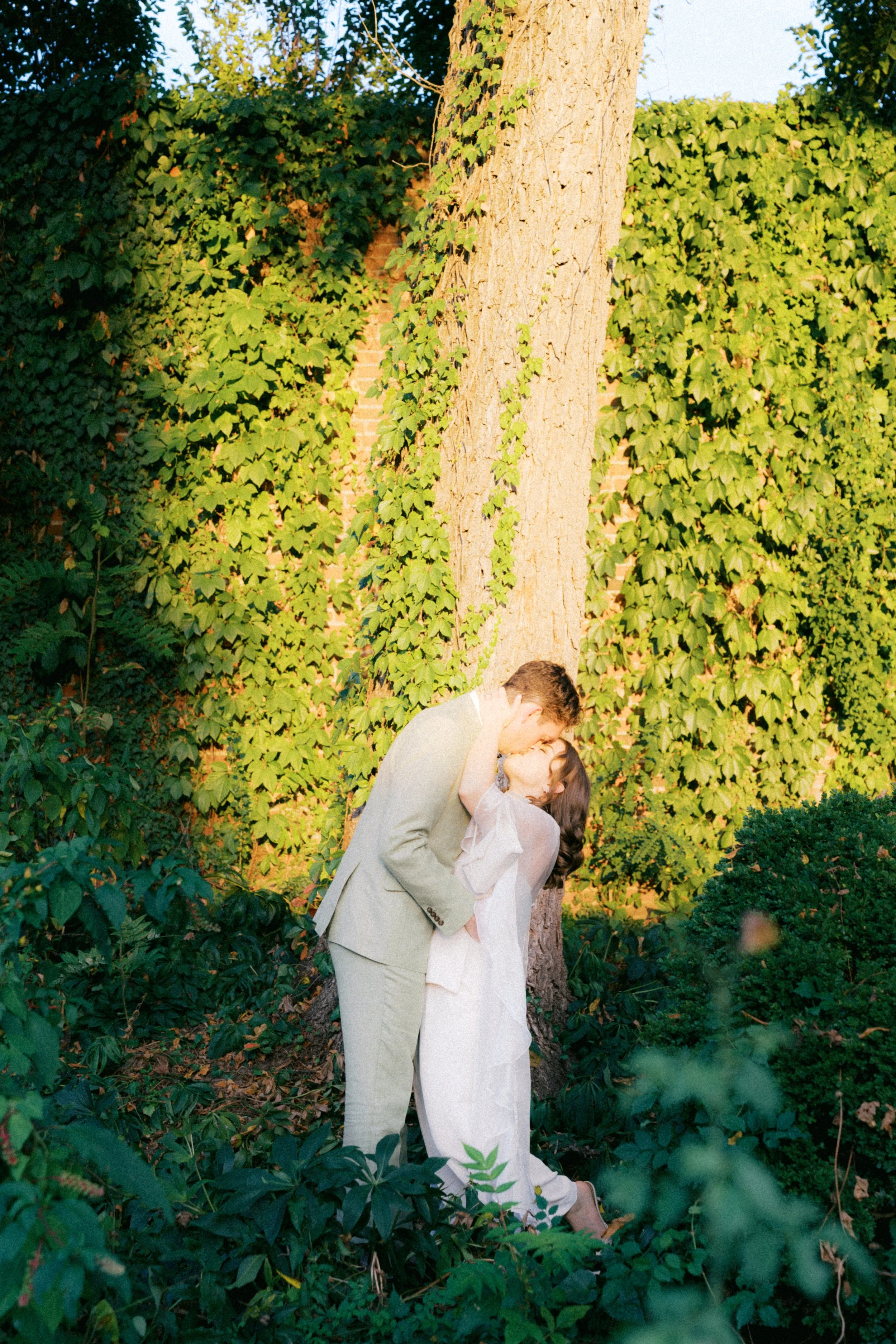 couple kissing in garden at old stone house in georgetown washington dc