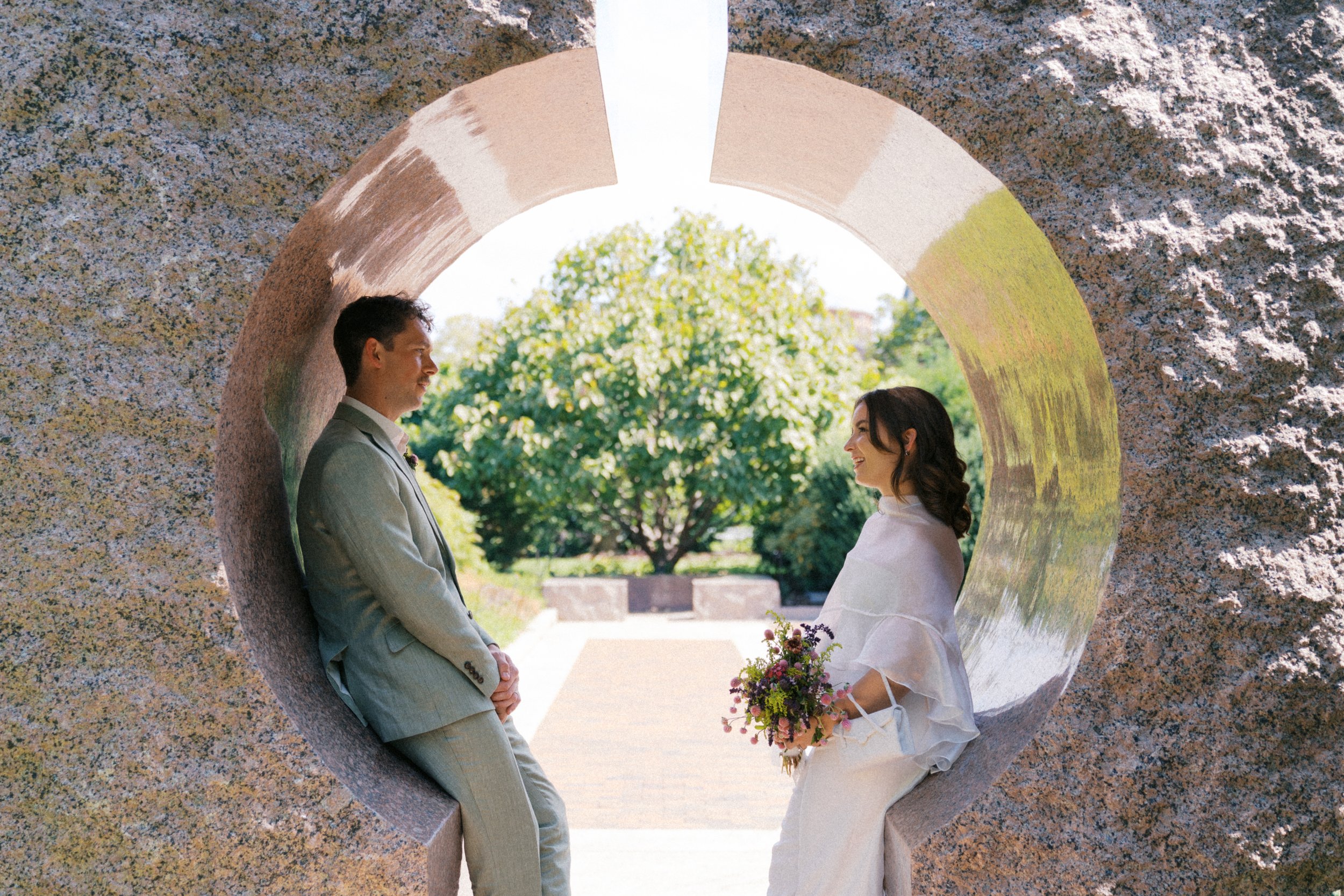 couple portraits inside circular stone sculpture at Smithsonian Gardens Washington DC elopement photography