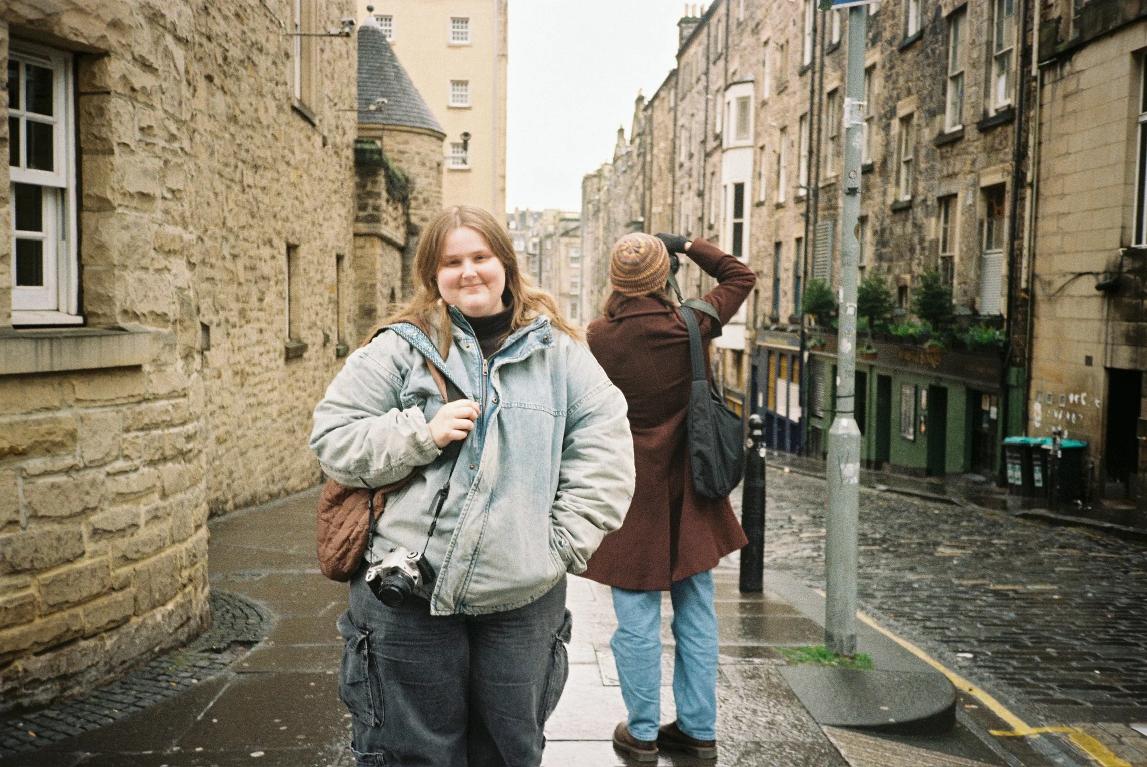 Smiling for a photo on the street on a January rainy day in Paris