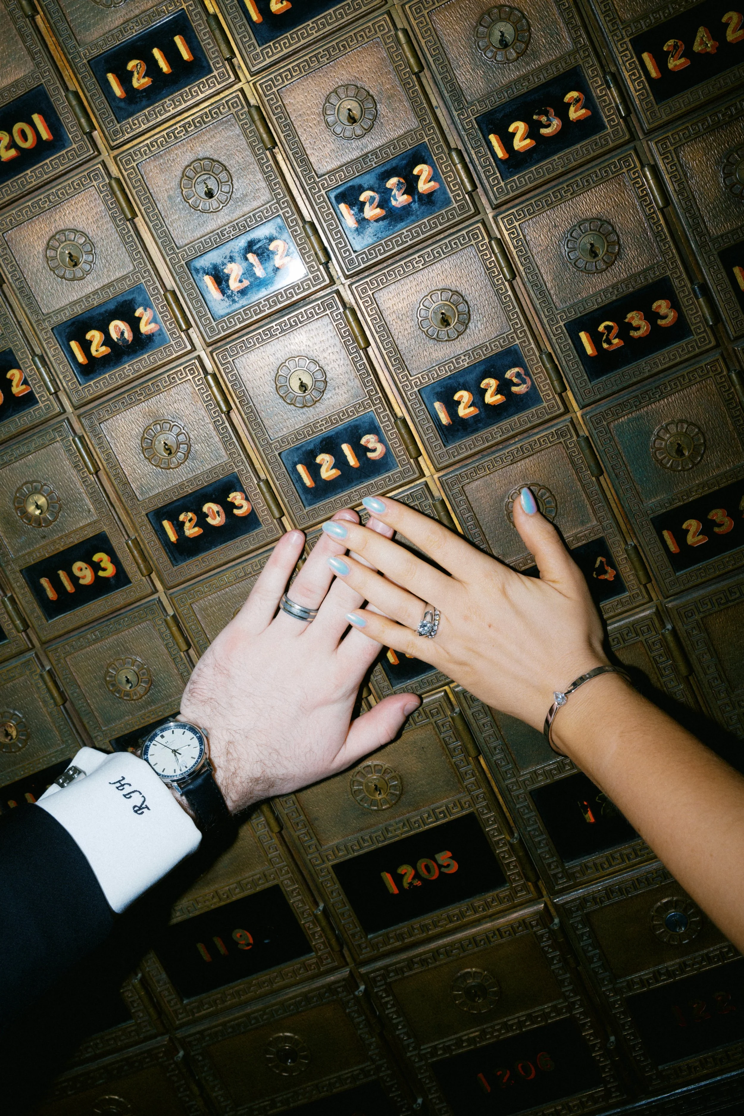 Bride and groom standing beneath historic architecture in Fort Worth