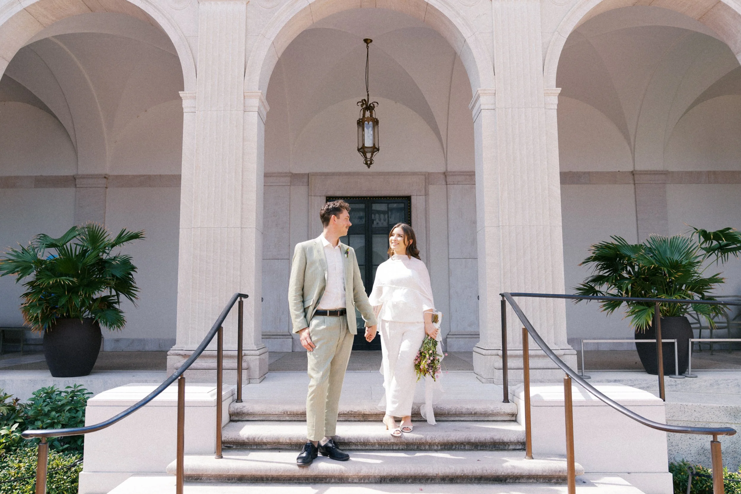 newly married couple on steps of national museum of asian art washington dc