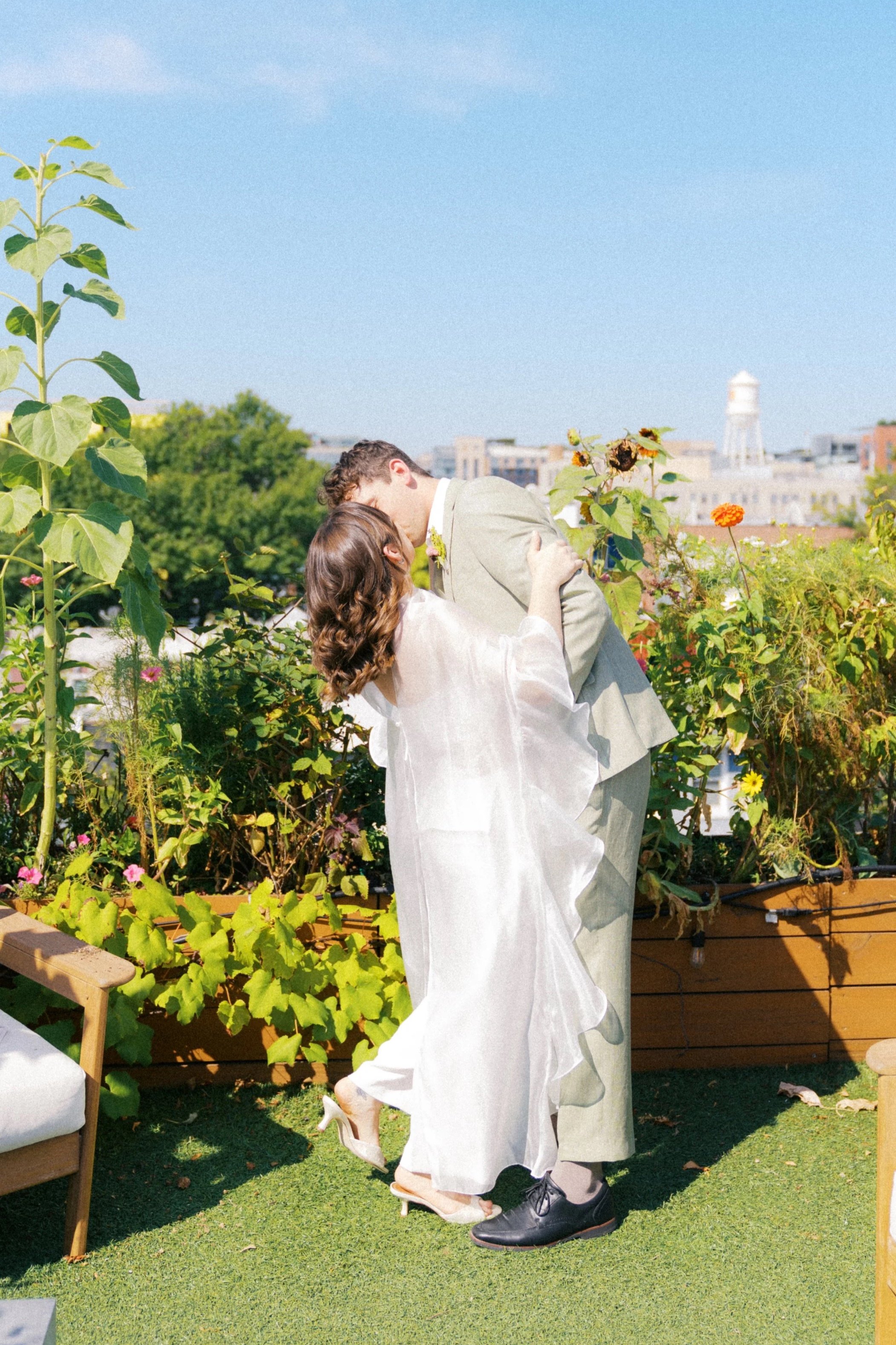 Rooftop Garden Elopement in Washington DC couple kissing during ceremony 