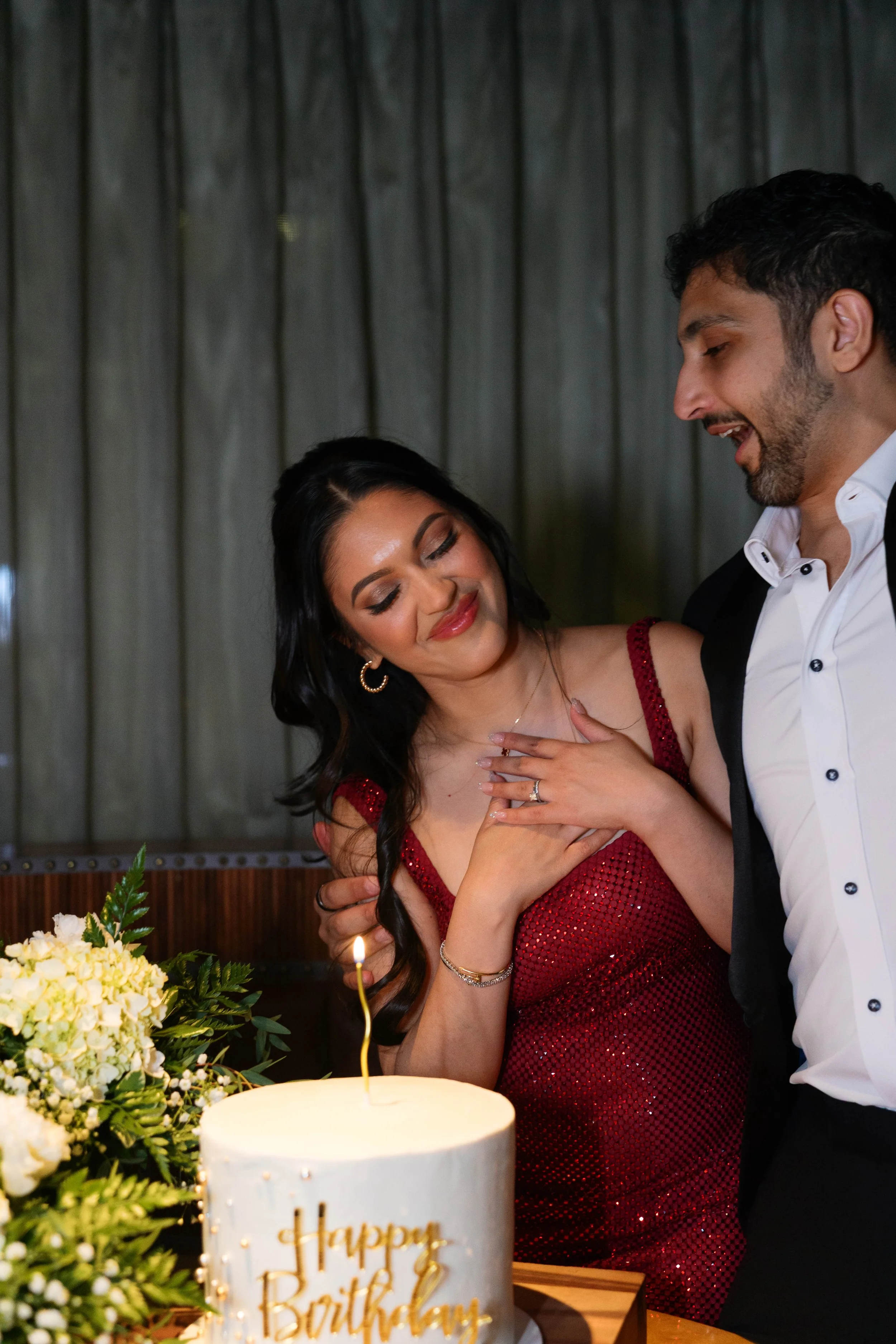 couple by birthday cake at Catbird Dallas 33rd celebration