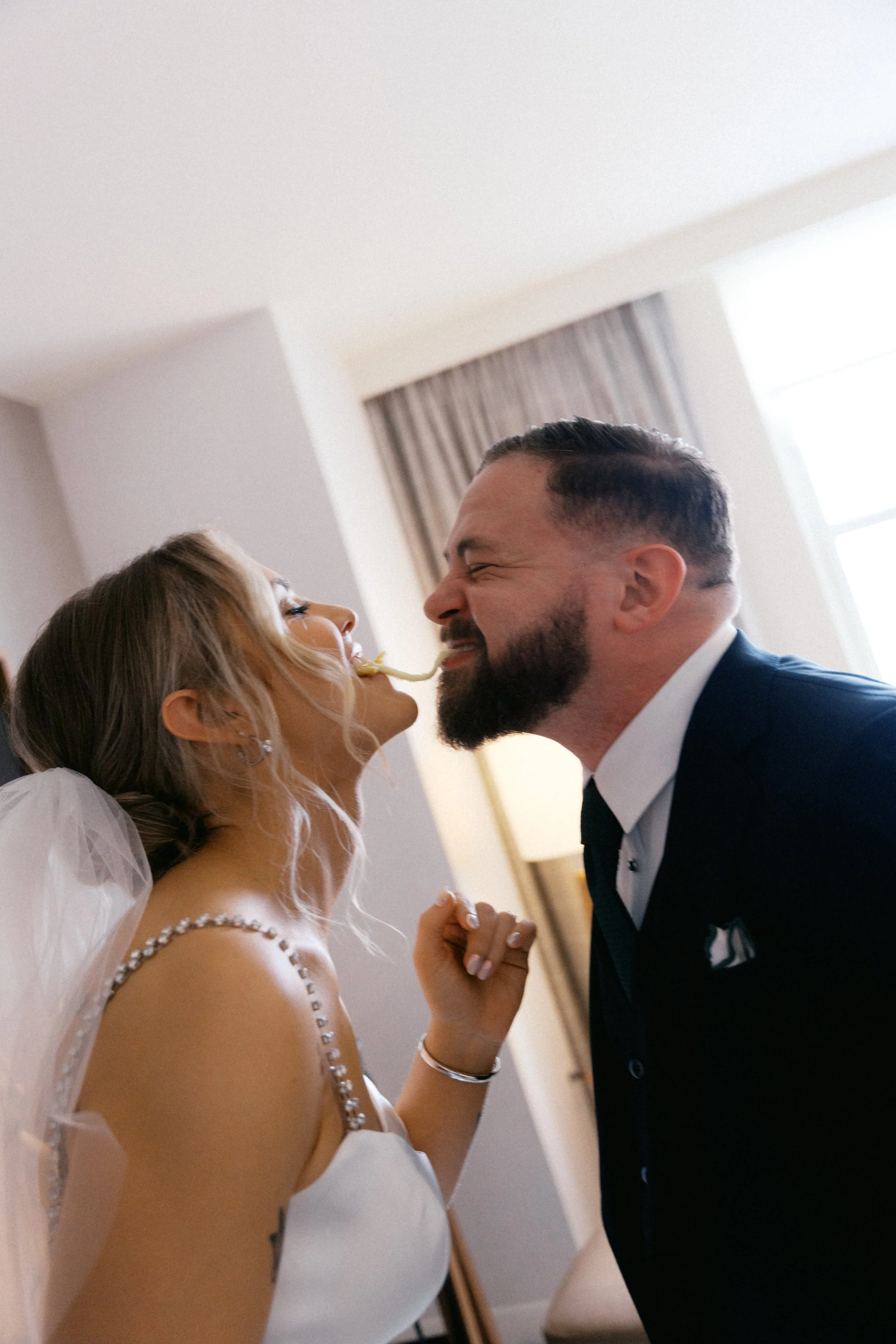 Couple sharing a mozzarella stick near window at Kimpton Harper Hotel