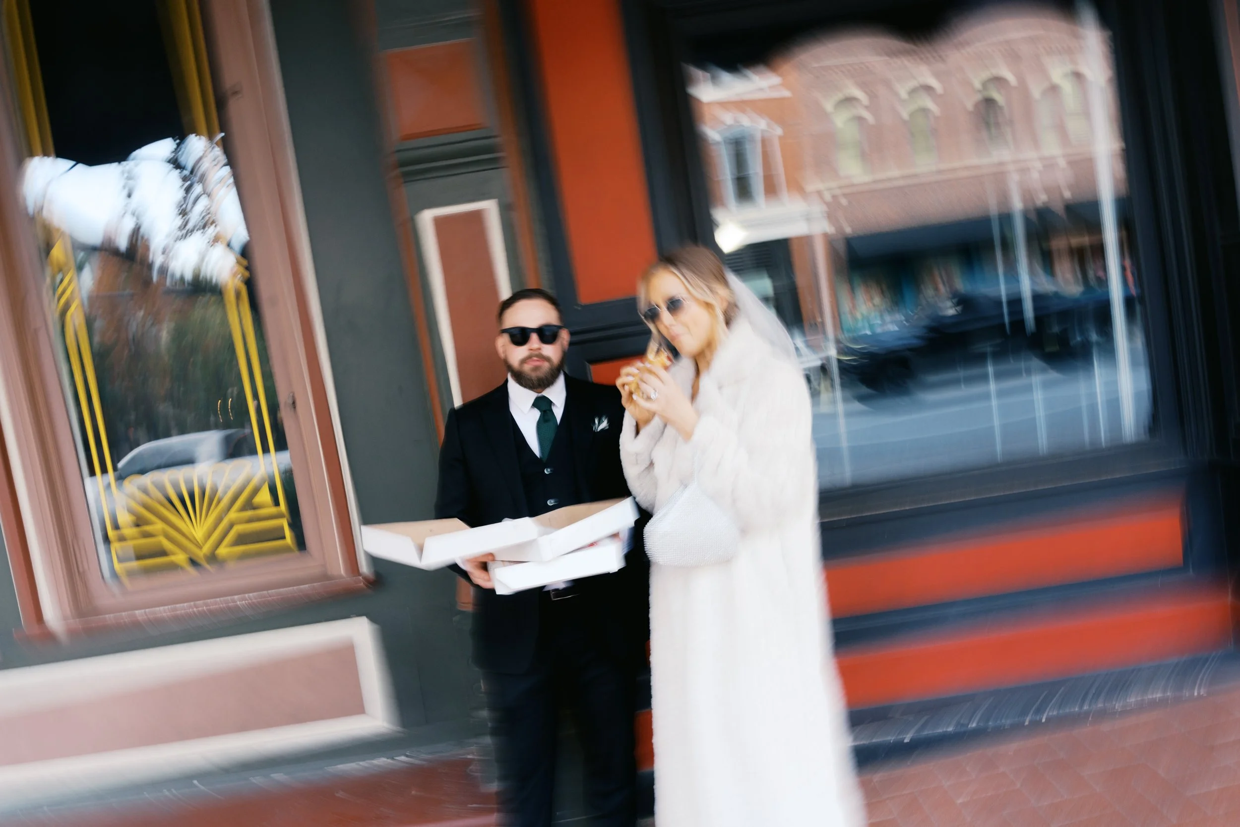 Wedding portraits eating pizza in Sundance Square Fort Worth
