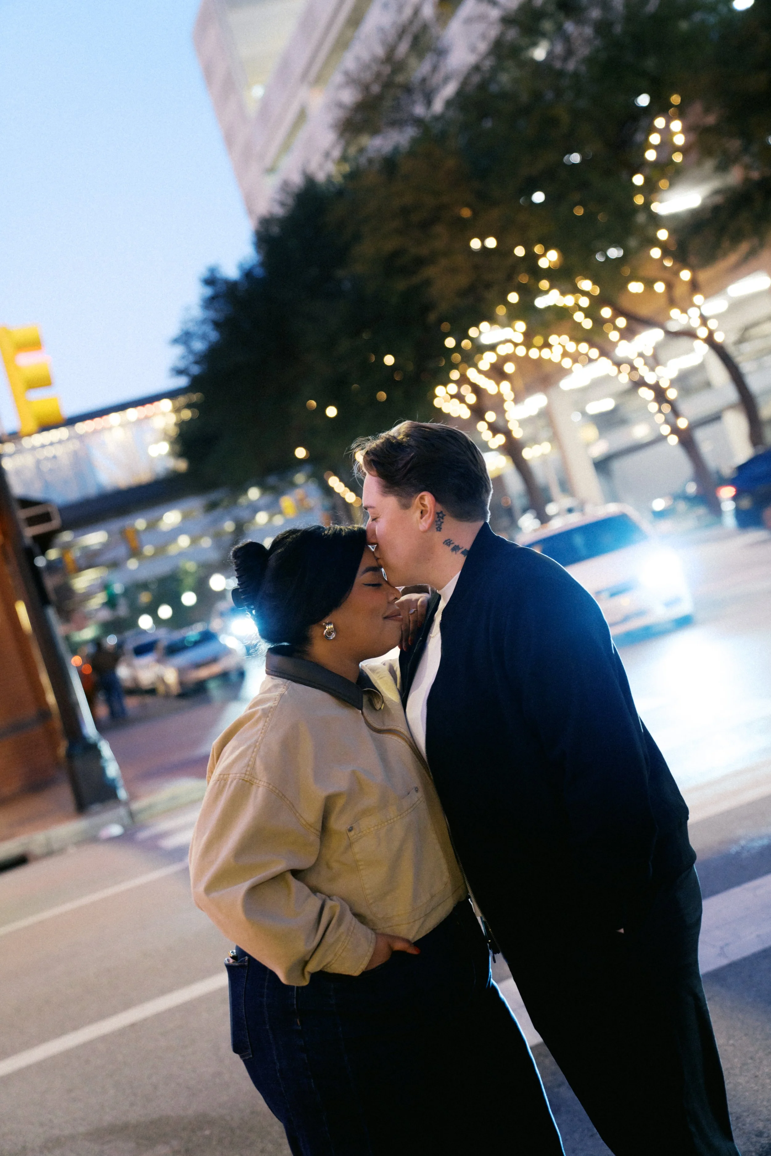 couple kissing at night in downtown Fort Worth Texas portrait session