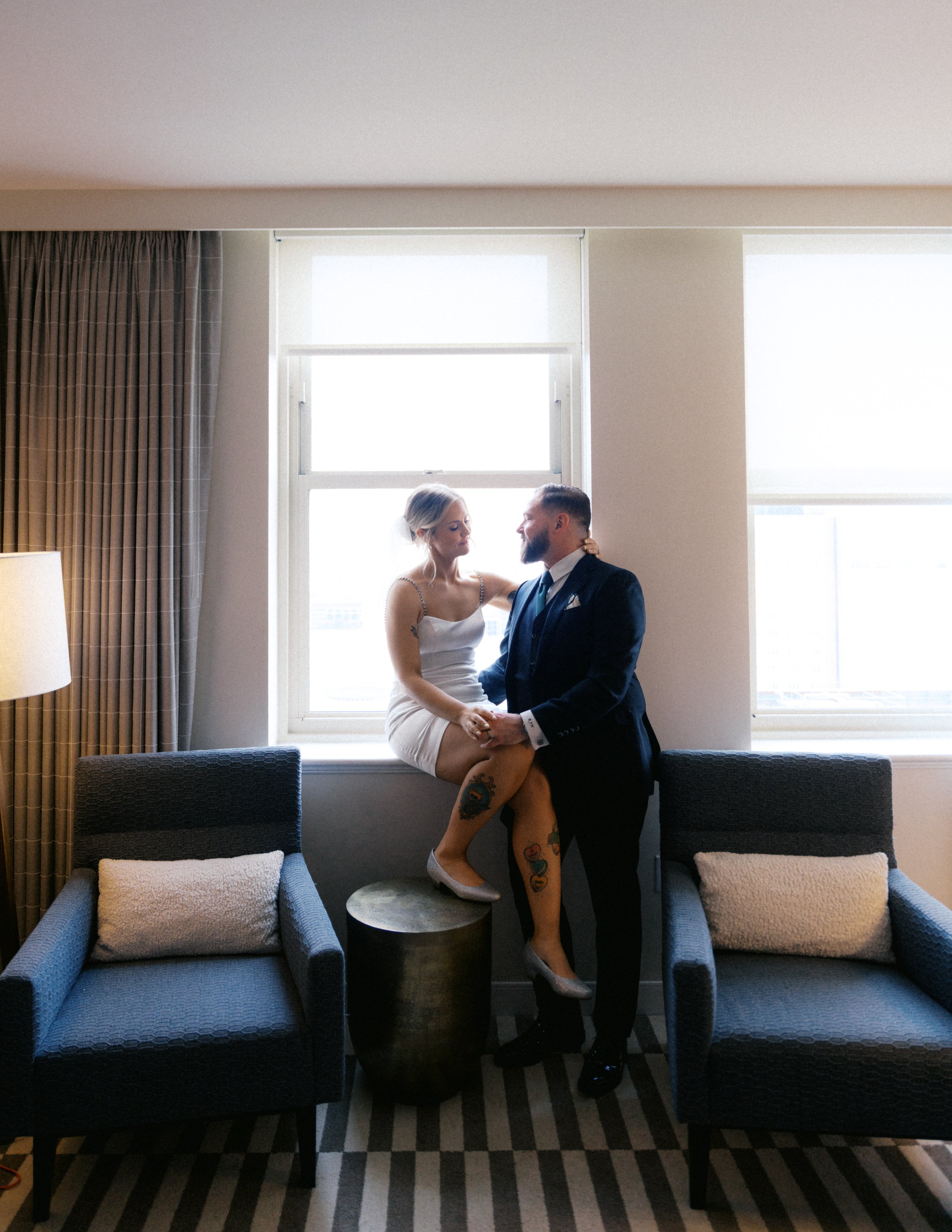 Couple sharing quiet moment near window at Kimpton Harper Hotel