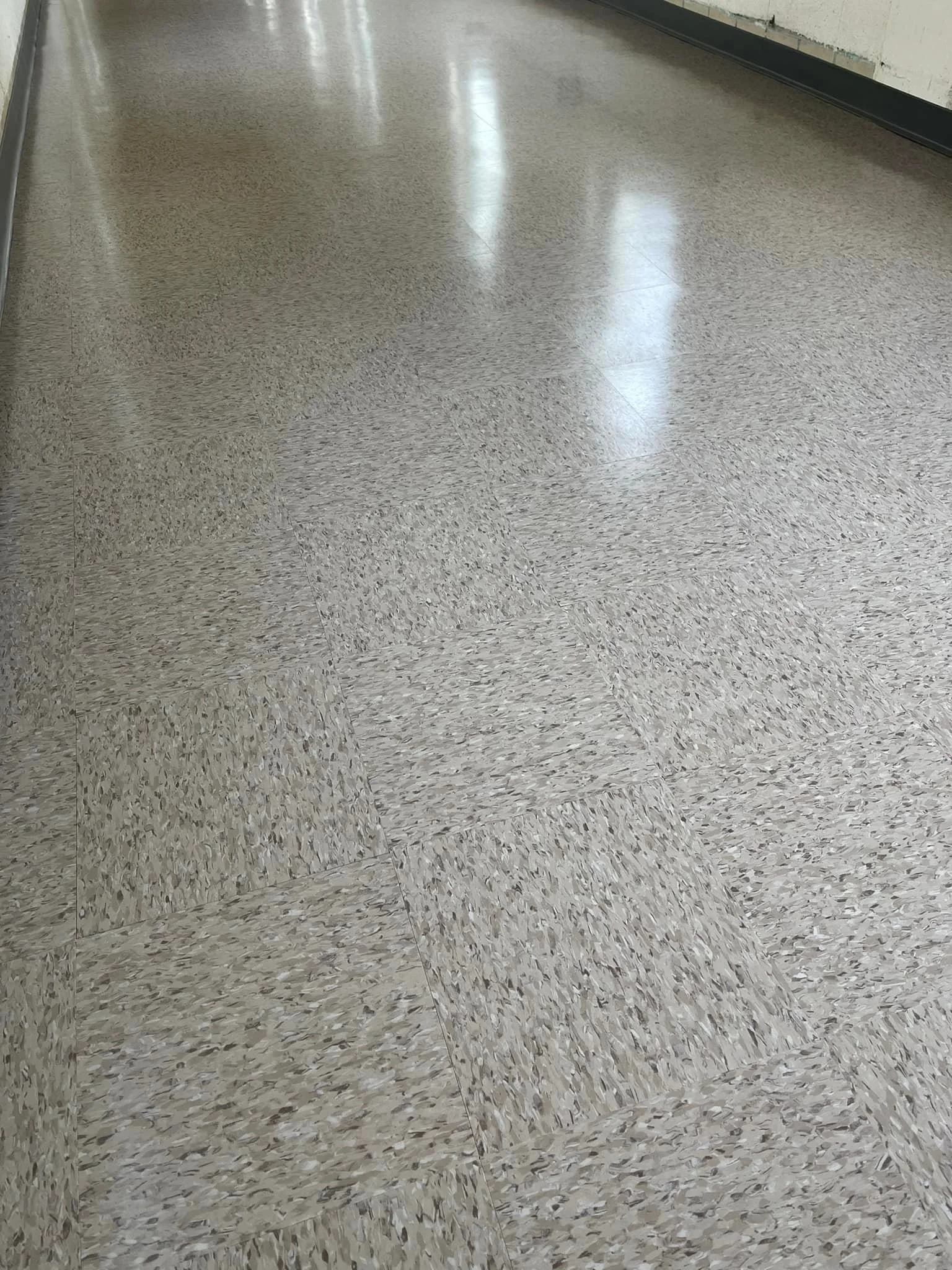 1 of 2 breezeways we completed. 2,300 sq ft of Armstrong Standard Excelon 51901 Taupe. We also applied 3 coats of Betco Hard As Nails floor finish. Finished off with Johnsonite 29 Moonrock rubber base.
