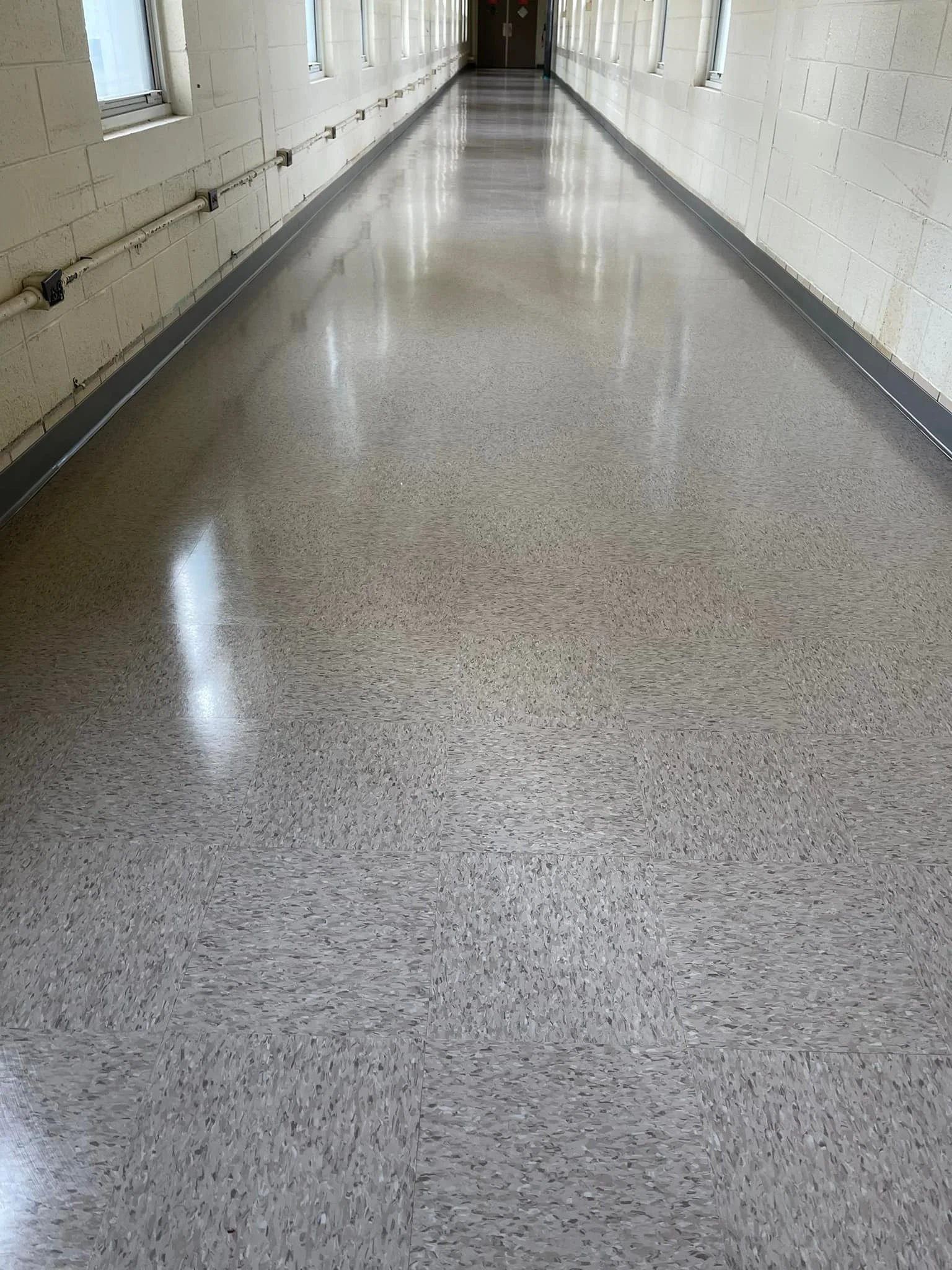 1 of 2 breezeways we completed. 2,300 sq ft of Armstrong Standard Excelon 51901 Taupe. We also applied 3 coats of Betco Hard As Nails floor finish. Finished off with Johnsonite 29 Moonrock rubber base.