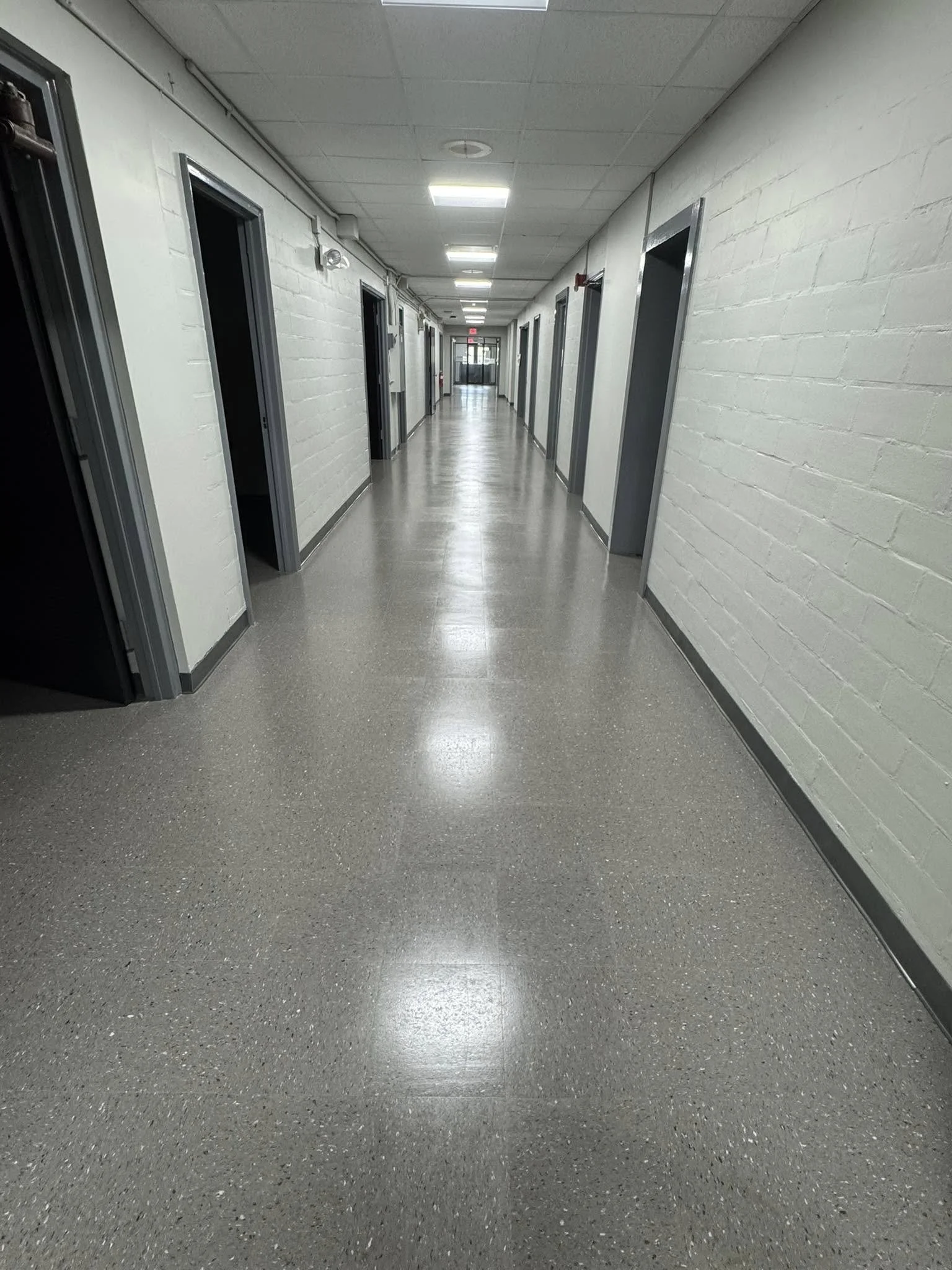 12,600 sqft - AHF Products - Iliad - Falcon Gray
2,640 LF - Roppe Corporation - 700 Series - 123 Charcoal
Floors prepped with HPS Schönox ZM self-leveler in areas, SL in others. Tile waxed with Betco - Hard As Nails floor polish. 