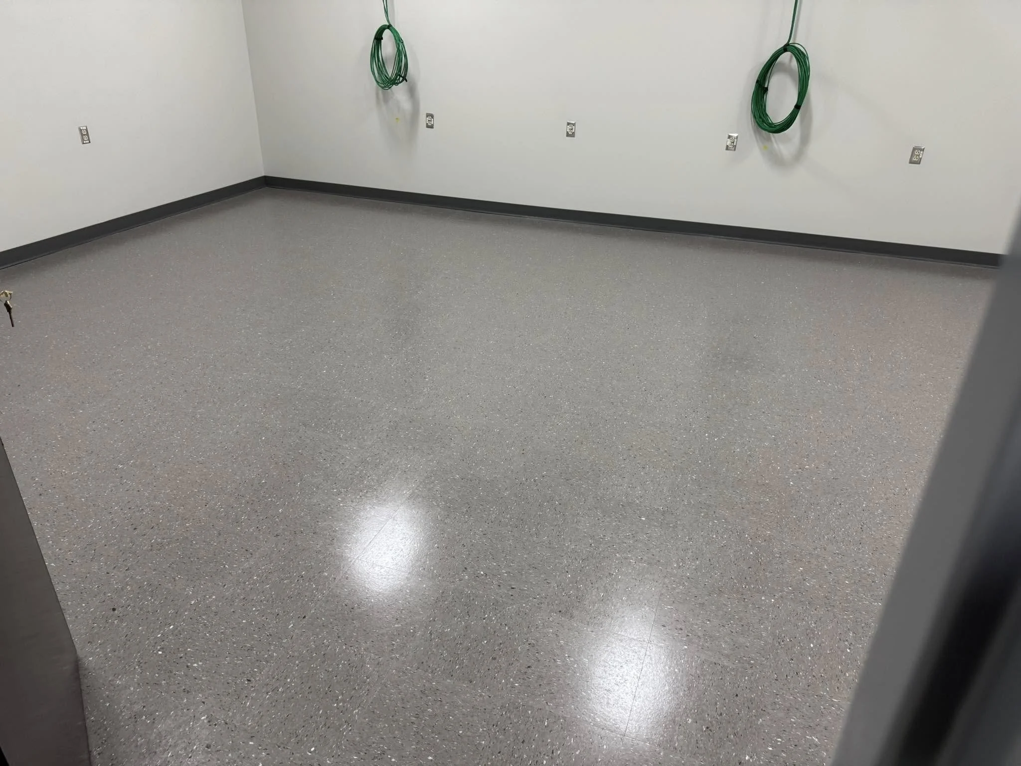 12,600 sqft - AHF Products - Iliad - Falcon Gray
2,640 LF - Roppe Corporation - 700 Series - 123 Charcoal
Floors prepped with HPS Schönox ZM self-leveler in areas, SL in others. Tile waxed with Betco - Hard As Nails floor polish. 