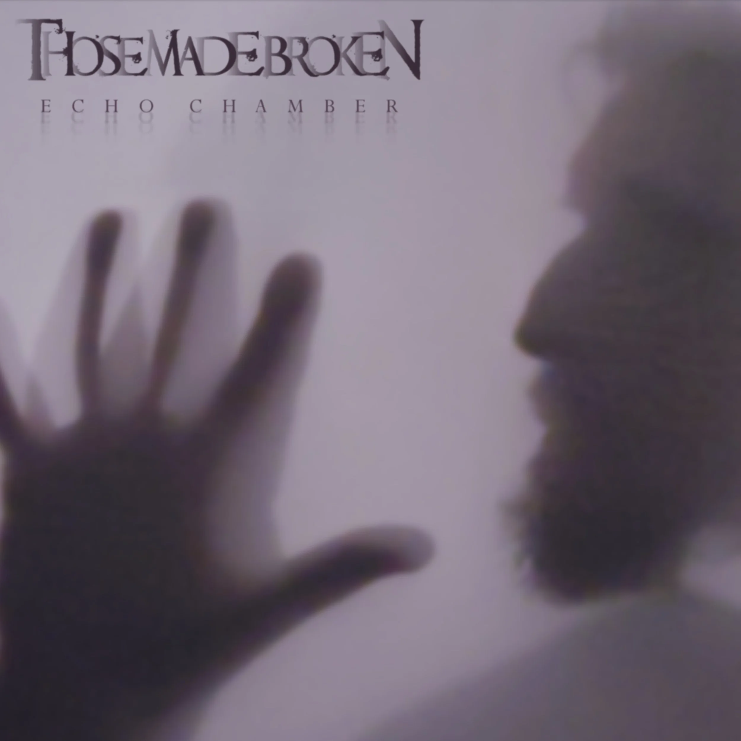 Blurred image of a hand touching a reflective surface with partial reflection of text that reads 'THOSE MADE BROKEN ECHO CHAMBER'. New Single, Out now on all streaming Platforms