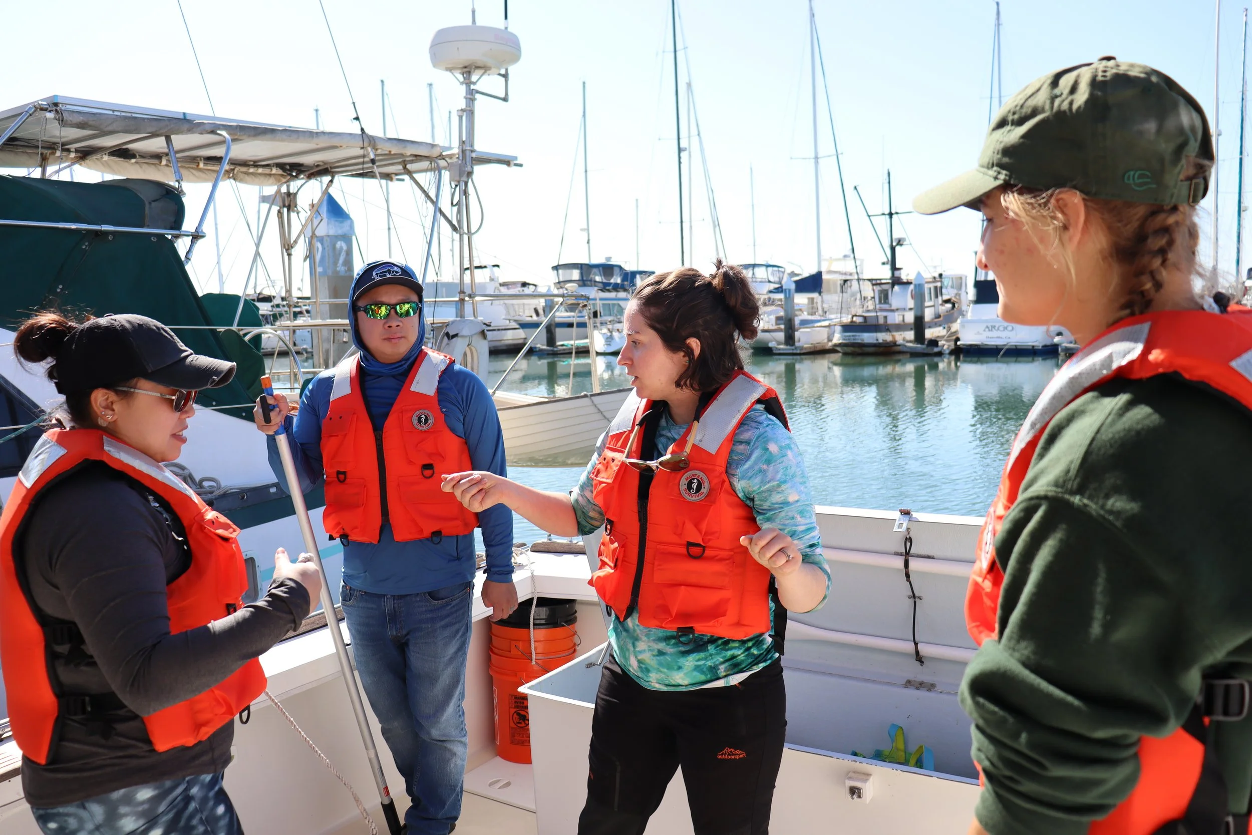Meghan Holst speaking to volunteers aboard research vessel.