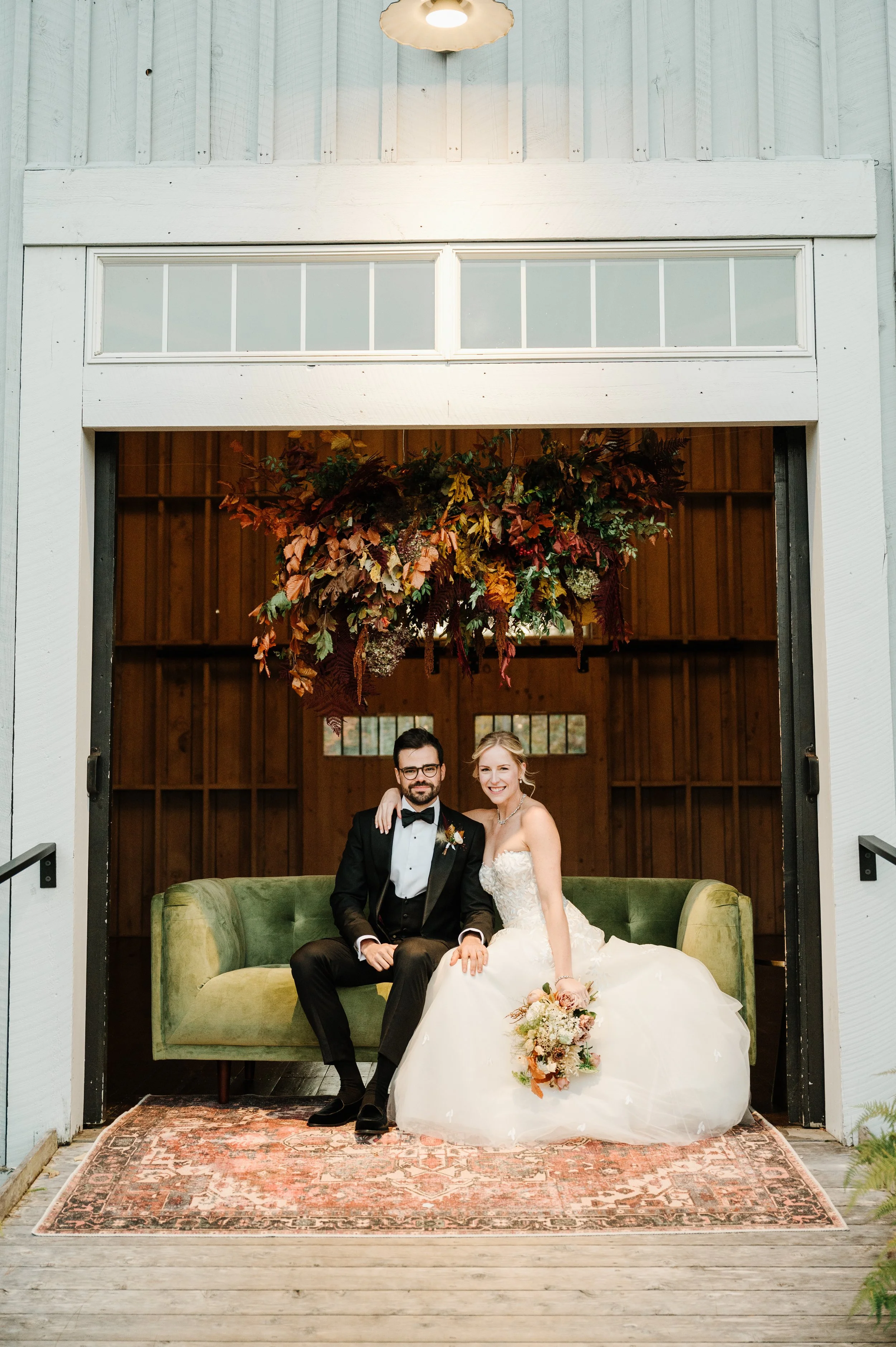 Bride and groom portrait inside rustic barn wedding venue in New England
