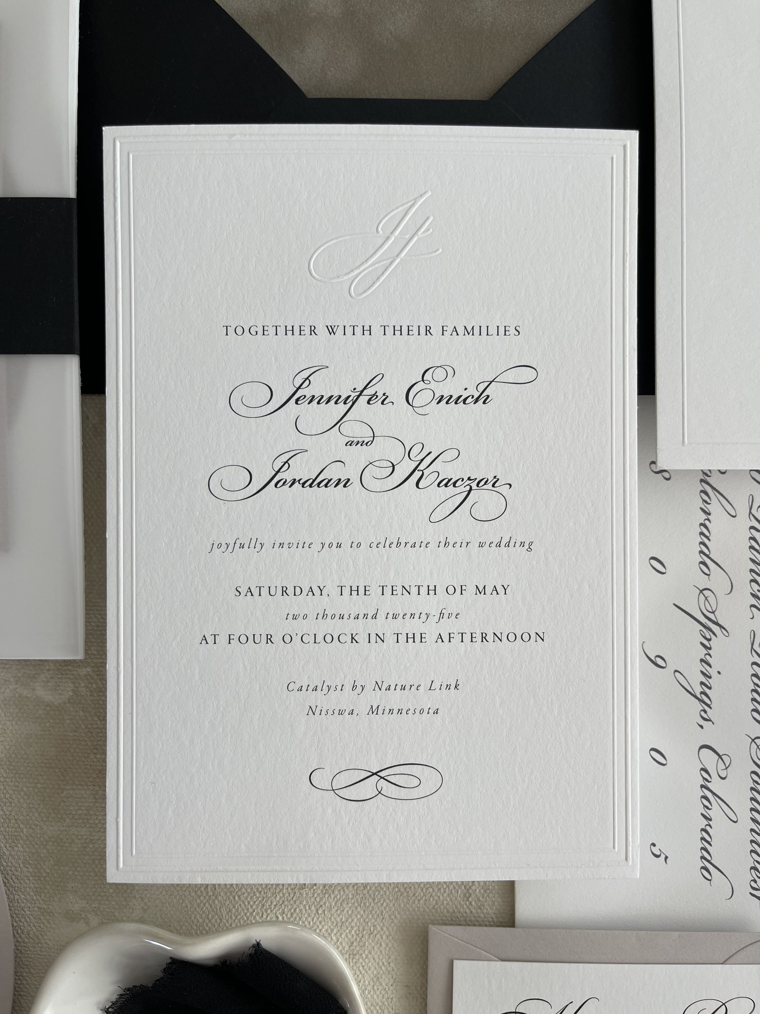 embossed wedding invitation with monogram and calligraphy