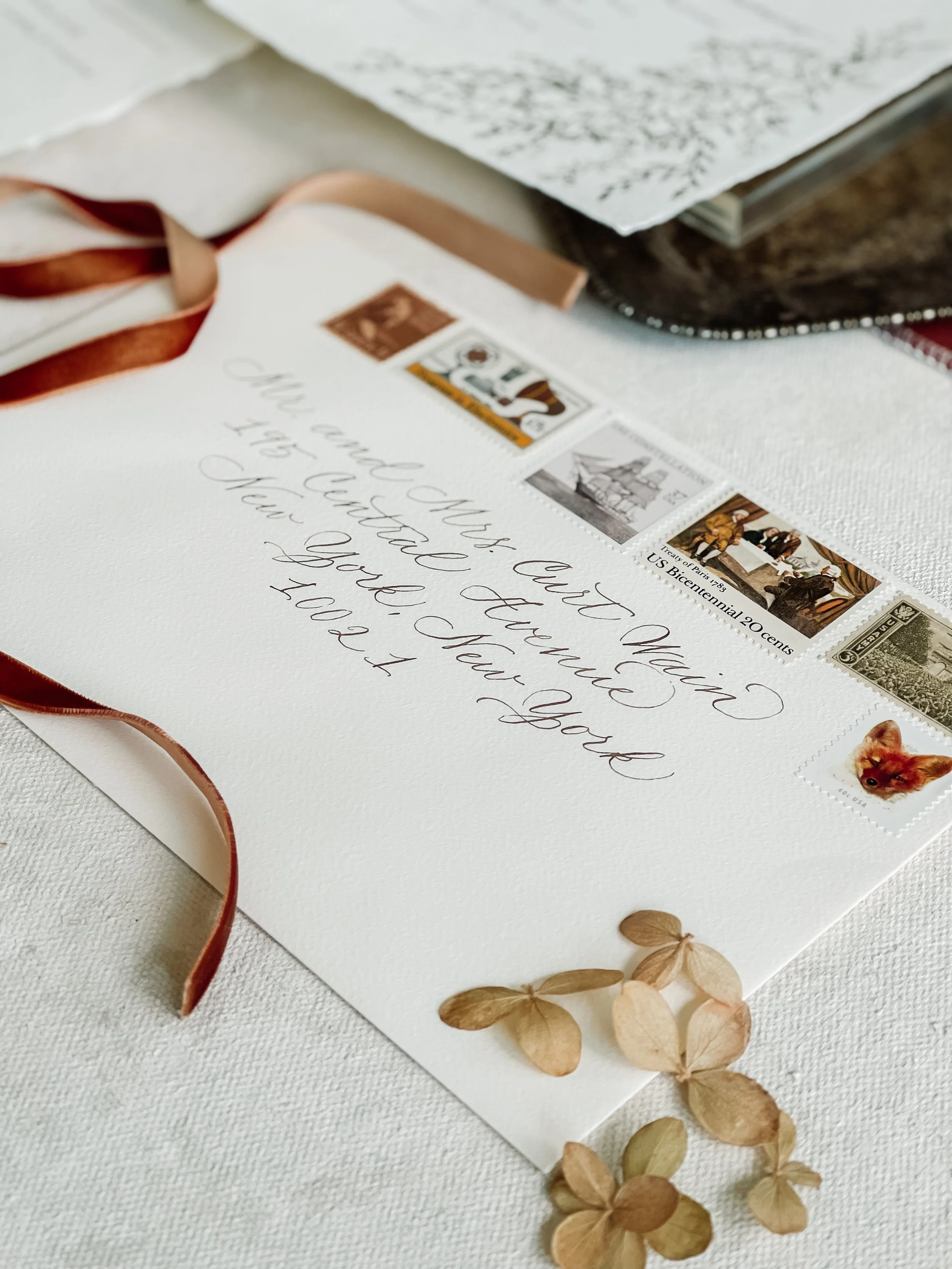 Wedding envelope  with handwritten calligraphy and vintage stamps