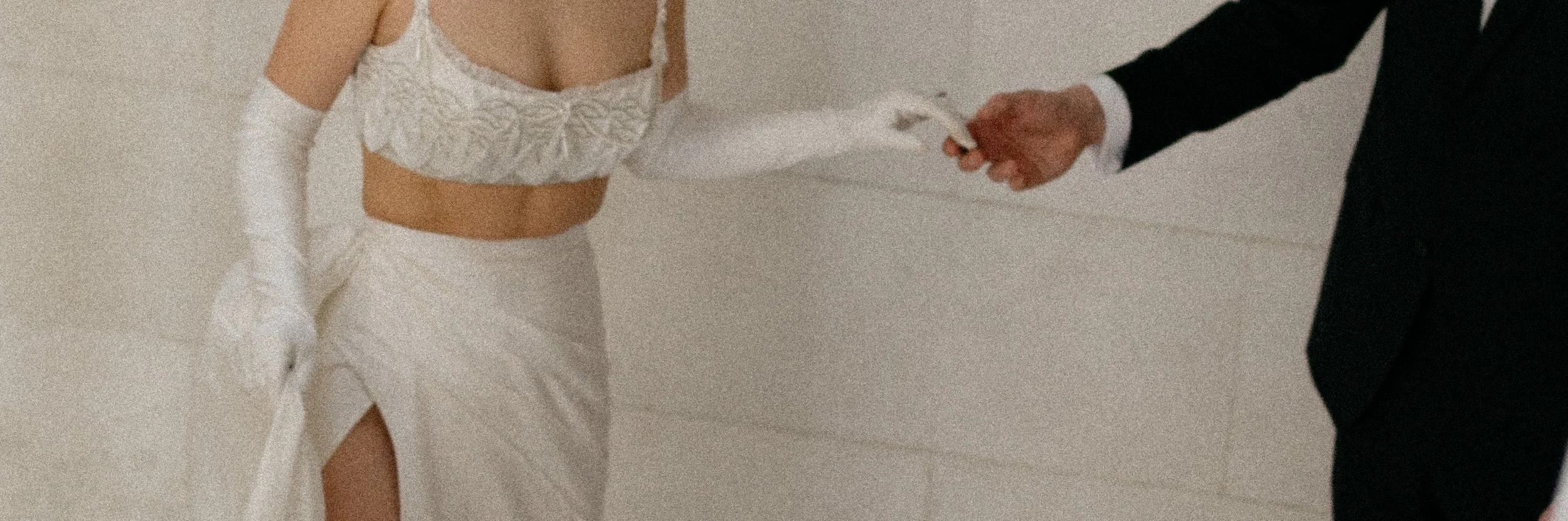 bride and groom touching hands