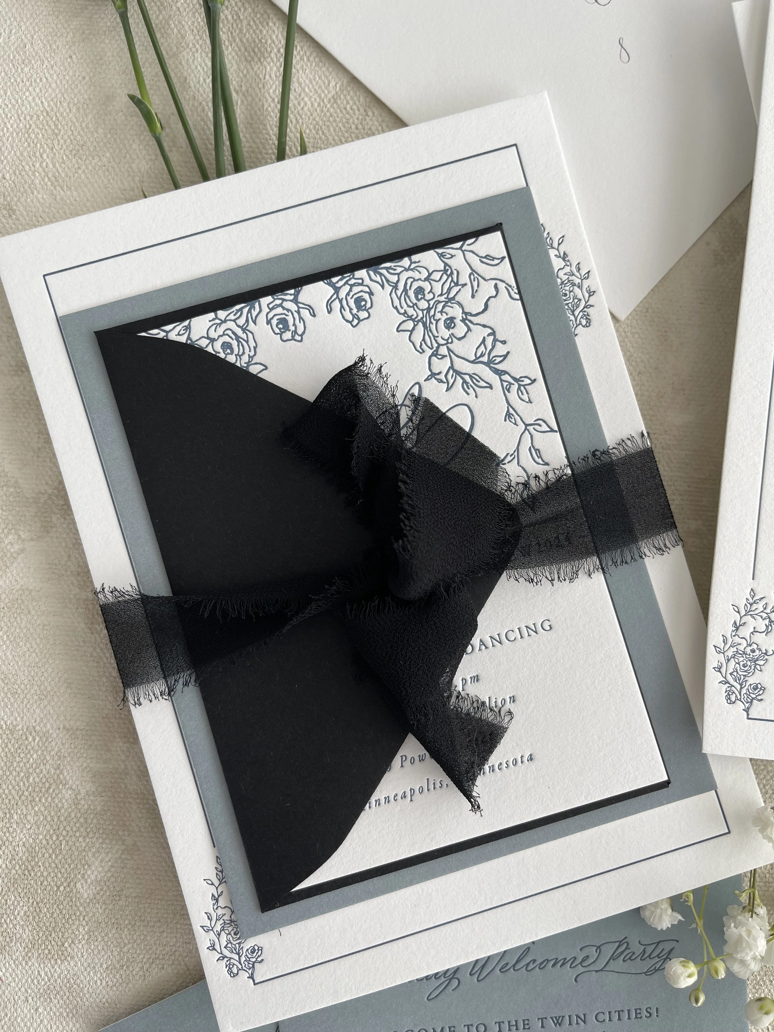 stacked-wedding-invitation-with-black-ribbon.jpeg