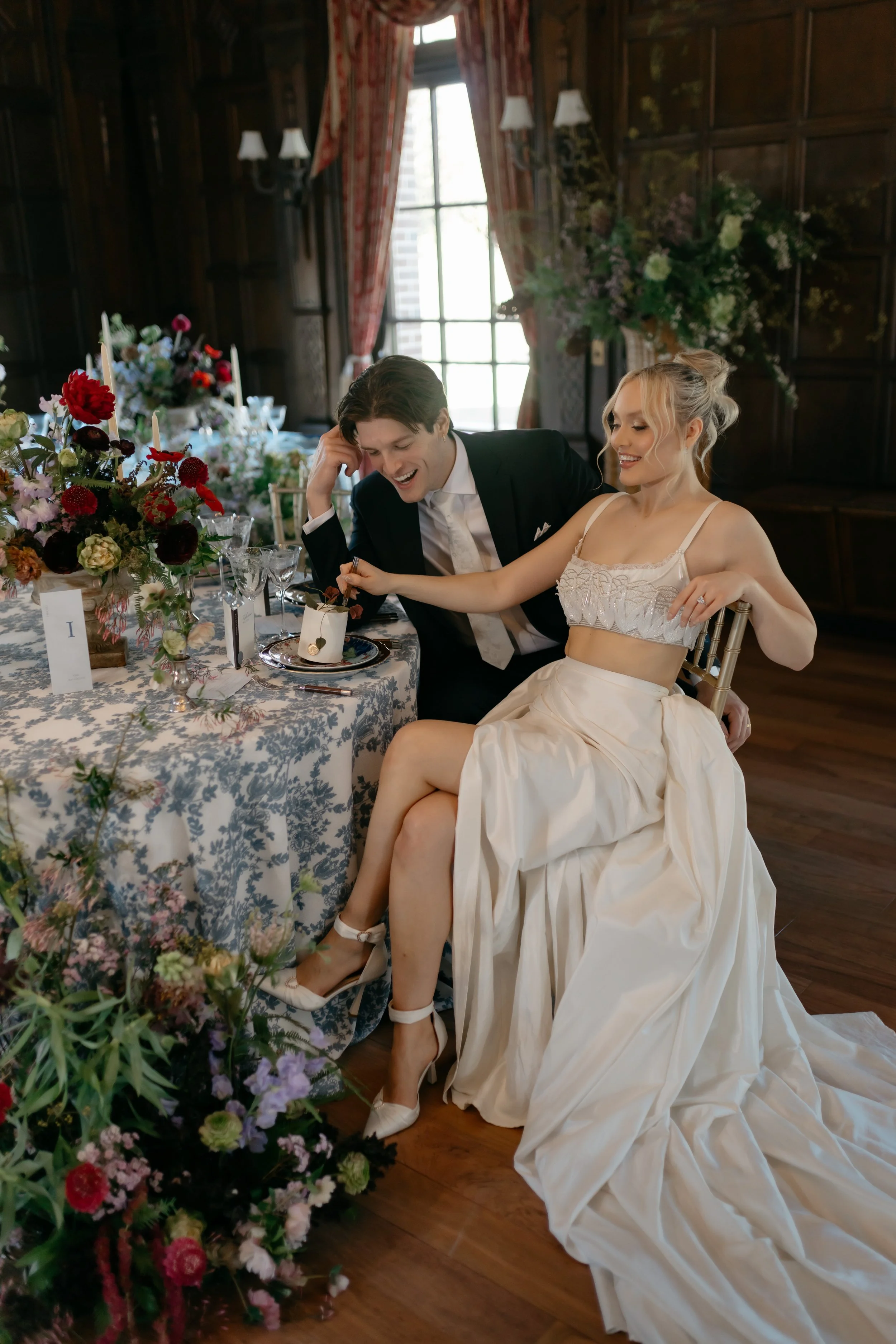 happy bride and groom sitting at wedding table