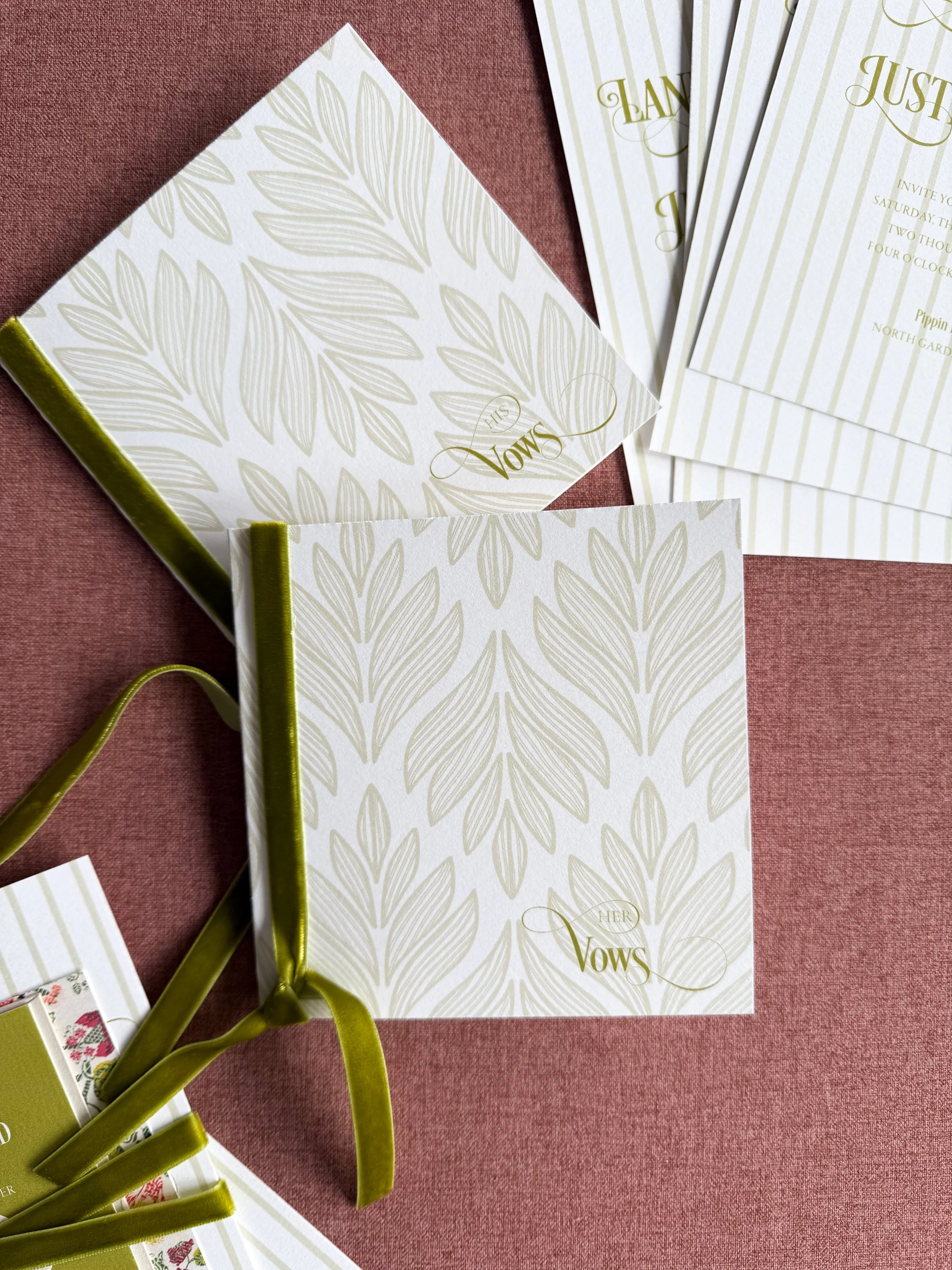 vow books with botanical print and velvet green ribbon